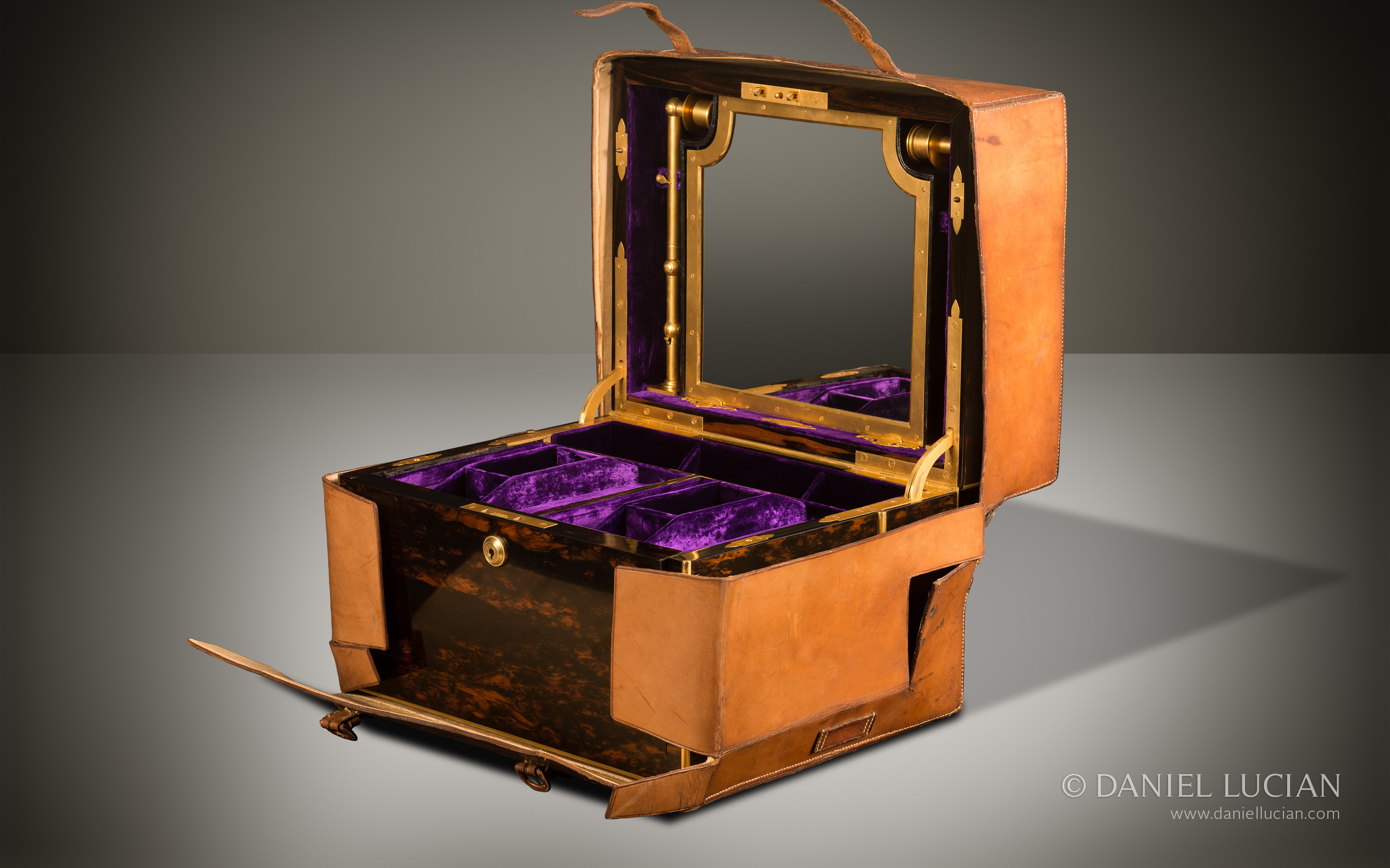Leather outer case for an Asprey antique jewellery box in coromandel with Betjemann Patent mechanism & candlesticks.