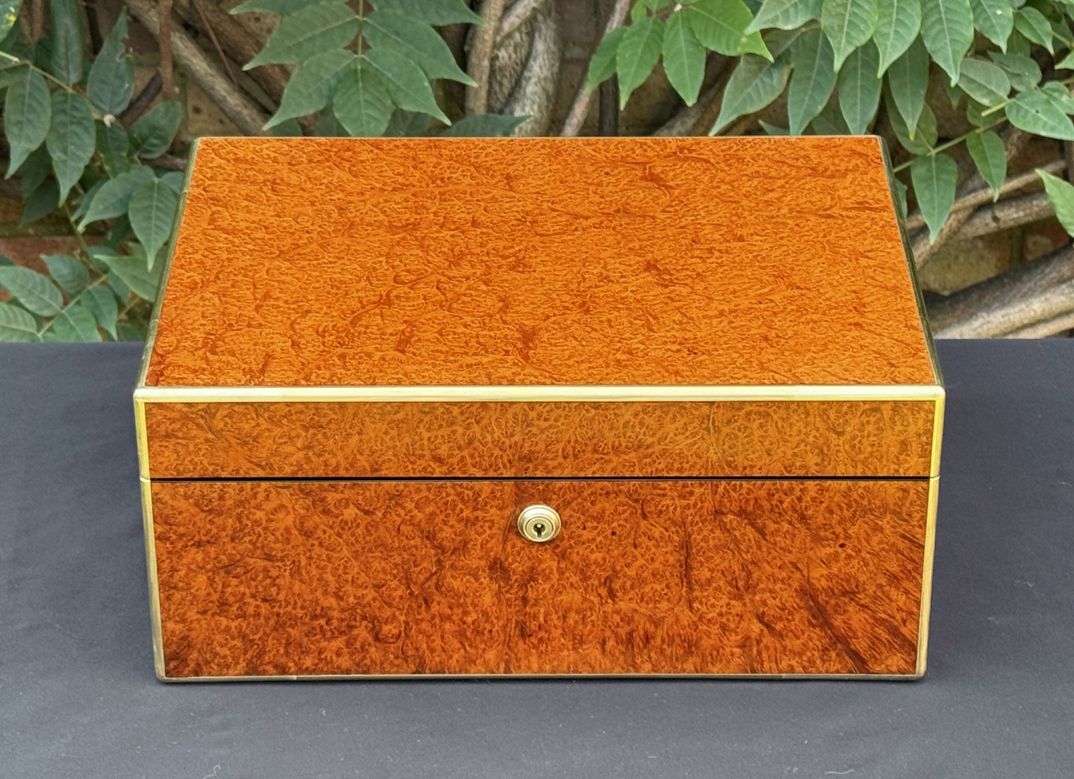 Front overhead view of an antique jewellery box in amboyna, by Edwards.