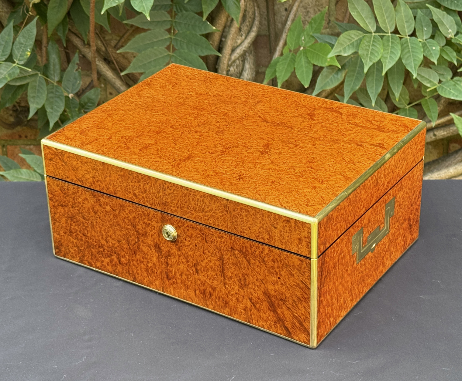 Front right view of an antique jewellery box in amboyna, by Edwards.