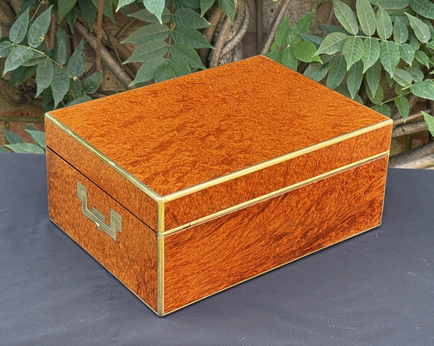 Rear right view of an antique jewellery box in amboyna, by Edwards.