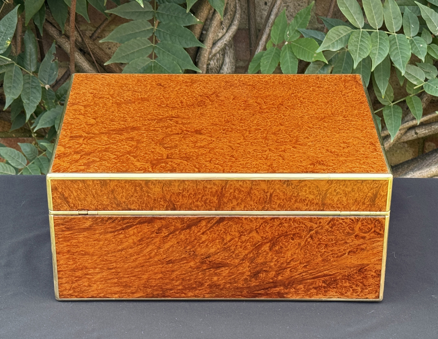 Rear view of an antique jewellery box in amboyna, by Edwards.