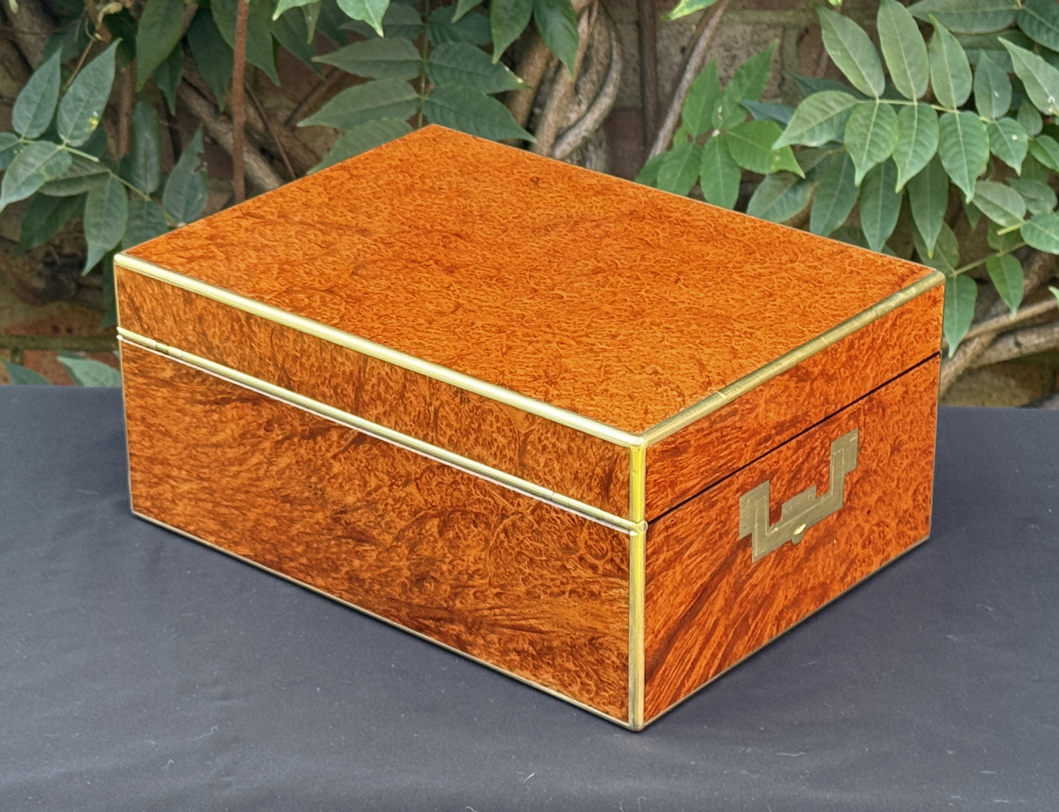 Rear left view of an antique jewellery box in amboyna, by Edwards.