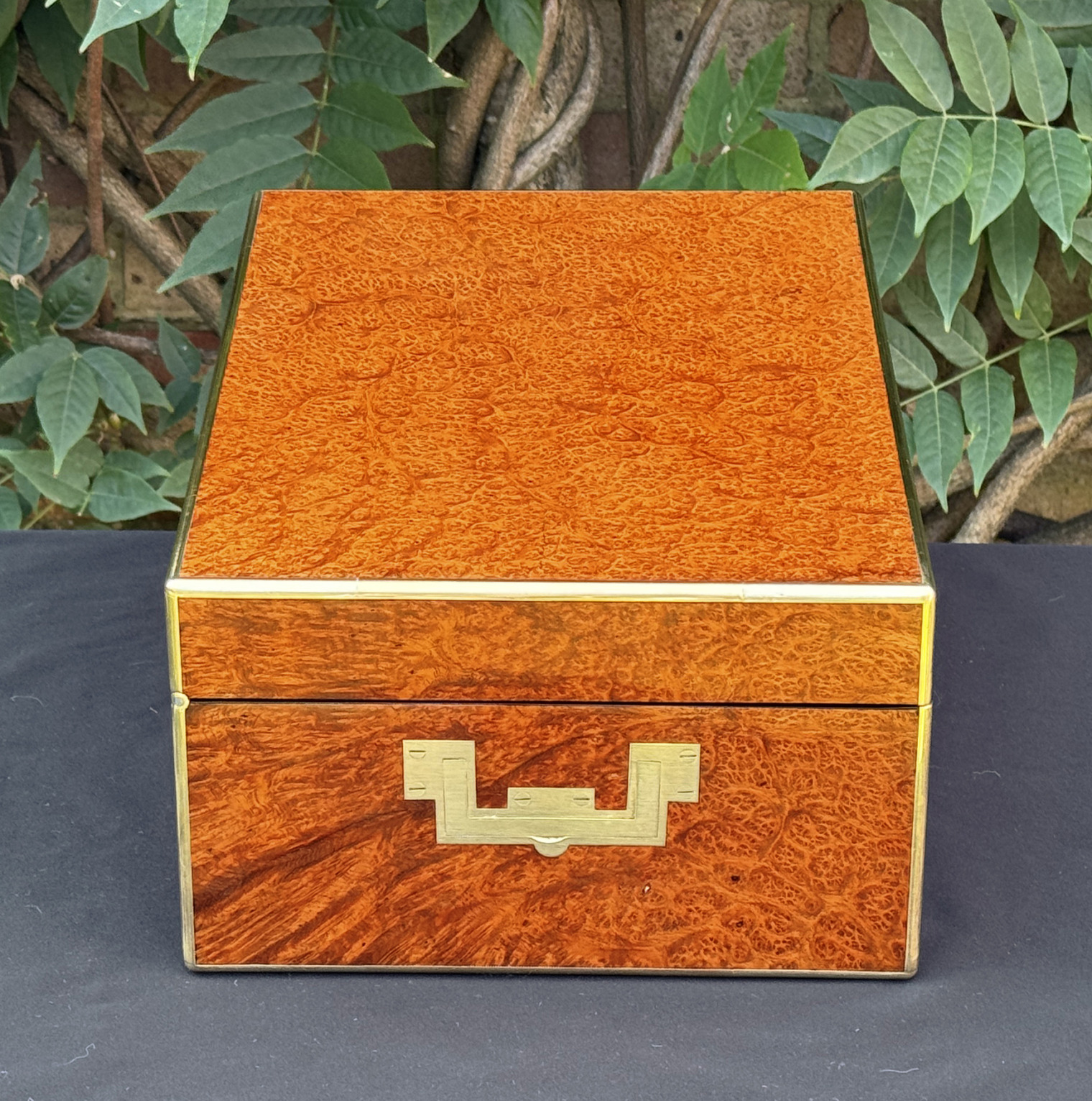 Left side view of an antique jewellery box in amboyna, by Edwards.
