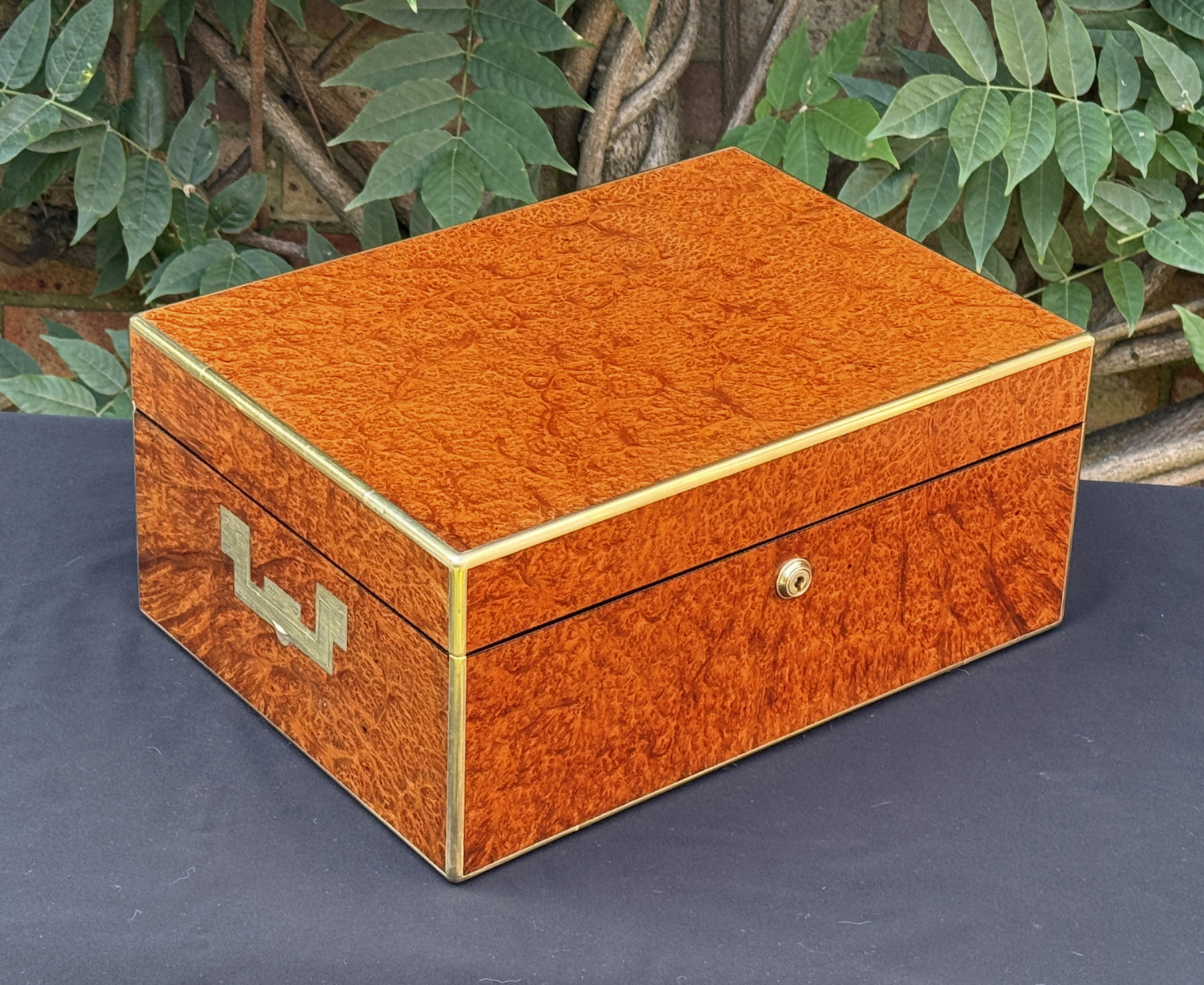 Front left view of an antique jewellery box in amboyna, by Edwards.