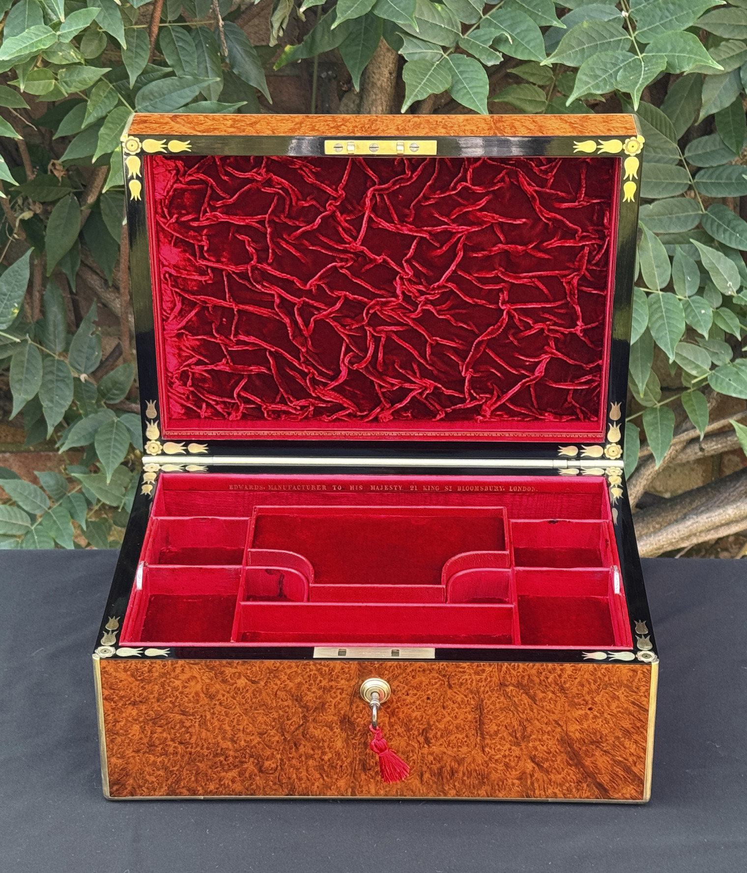 Front interior view of an antique jewellery box in amboyna, by Edwards.