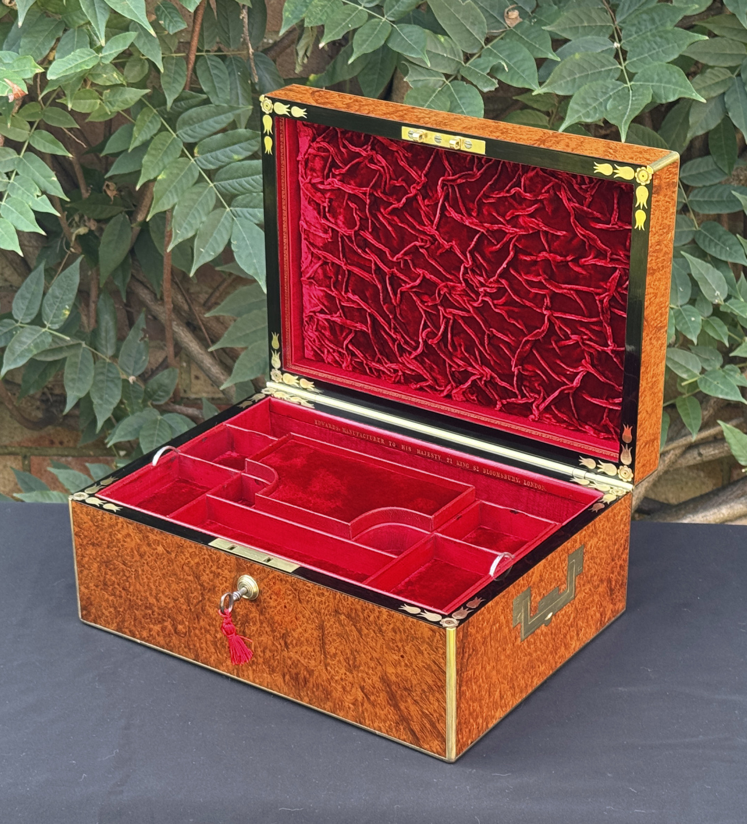 Front right interior view of an antique jewellery box in amboyna, by Edwards.