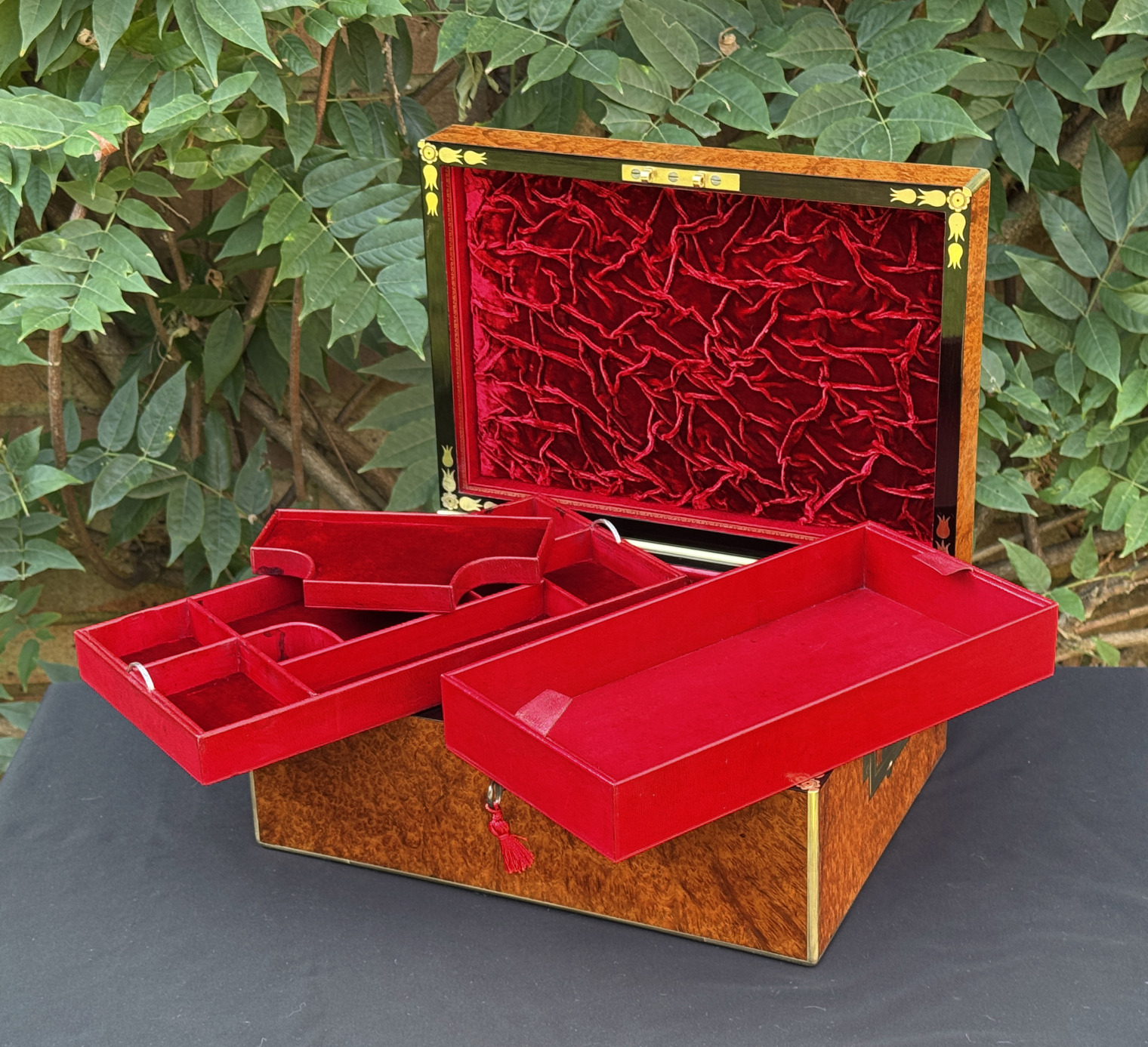 Front right interior view of an antique jewellery box in amboyna, by Edwards, with all three trays removed.