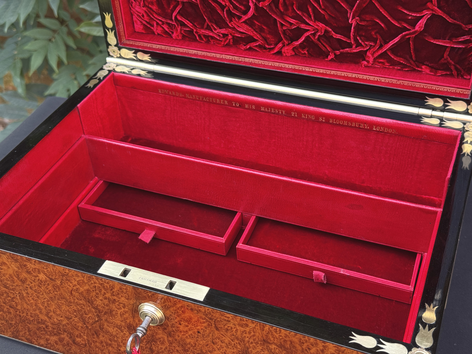 Closer interior view of an antique jewellery box in amboyna, by Edwards, with all three trays removed and concealed drawers on display.