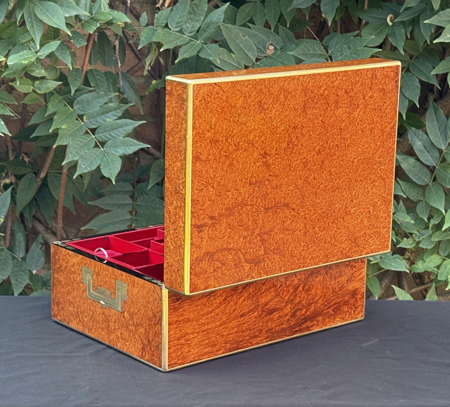 Rear right opened view of an antique jewellery box in amboyna, by Edwards.