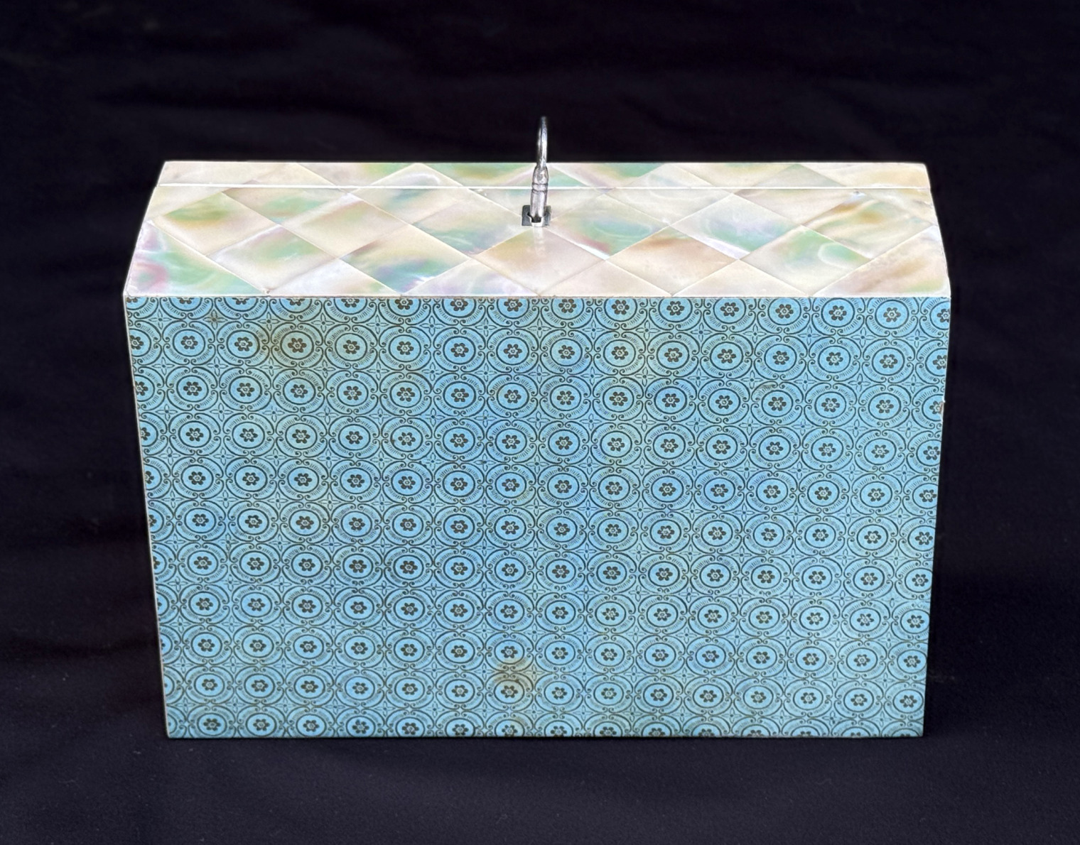 Underside view of an antique mother of pearl inlaid jewellery box.
