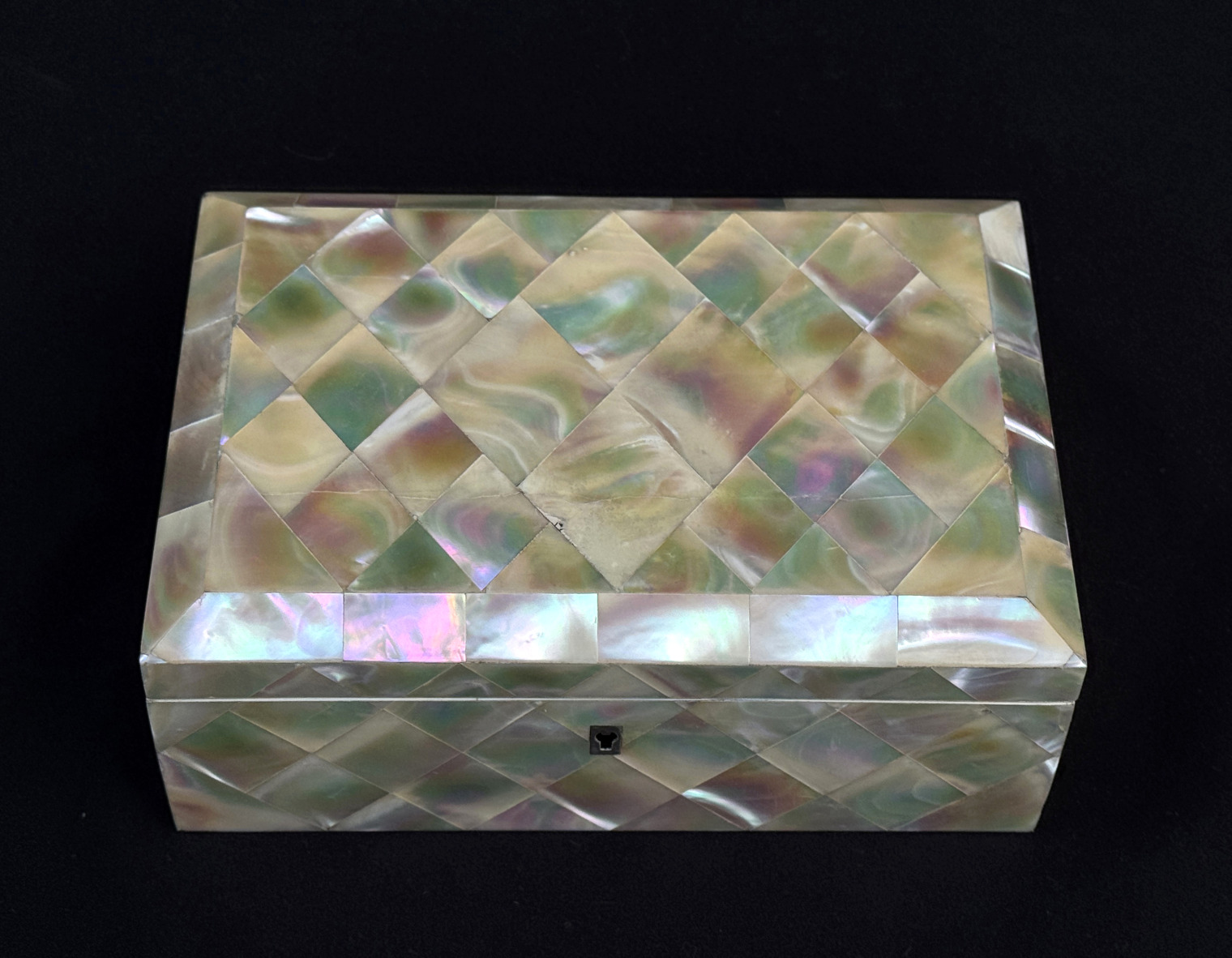 Overhead view of an antique mother of pearl inlaid jewellery box.