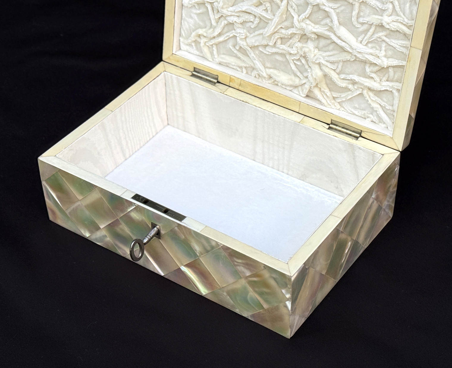 Closer interior view of an antique mother of pearl inlaid jewellery box.