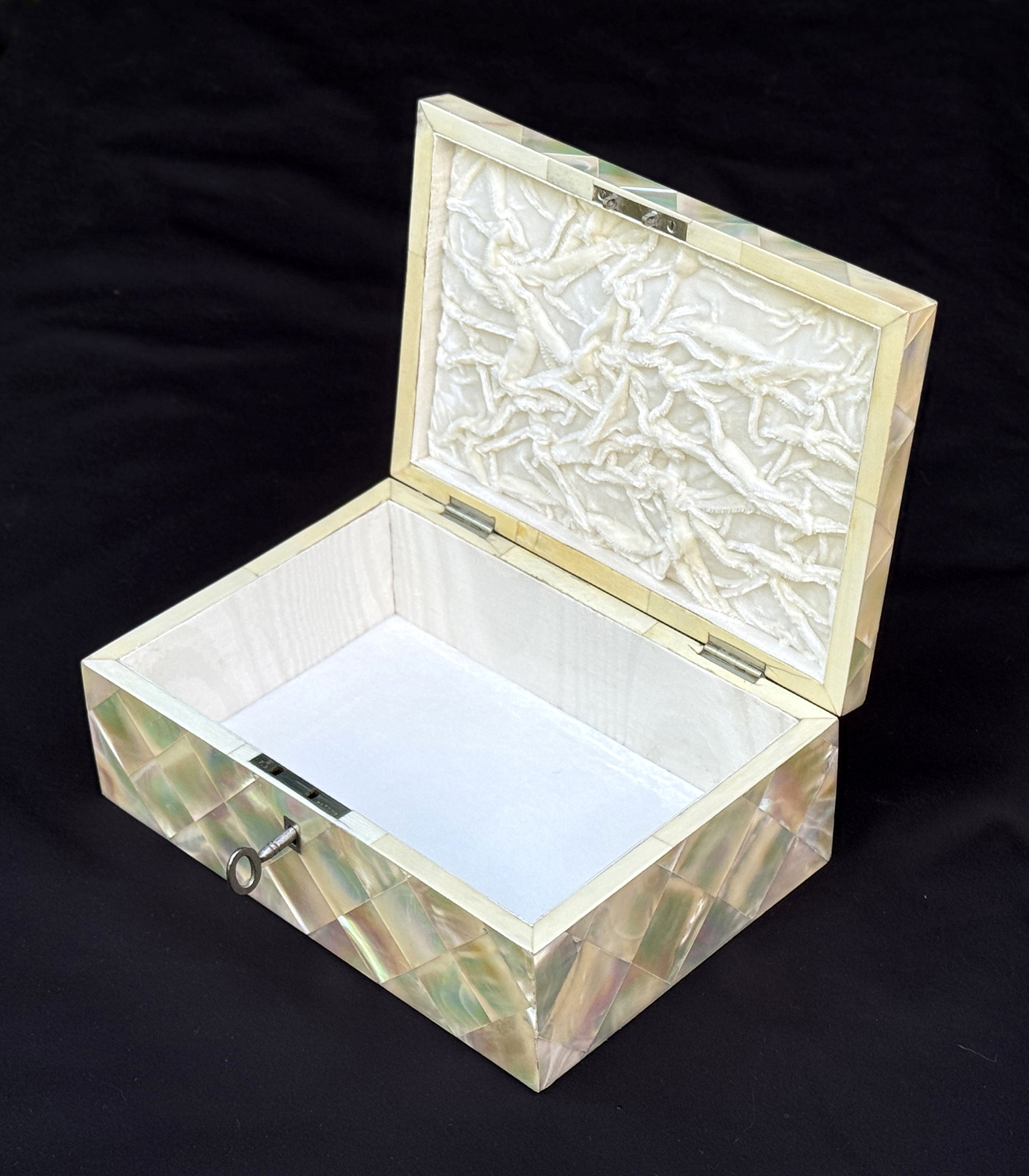Front right interior view of an antique mother of pearl inlaid jewellery box.