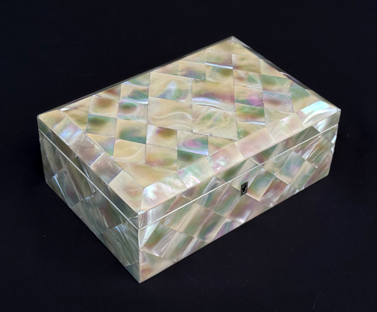 Front left view of an antique mother of pearl inlaid jewellery box.