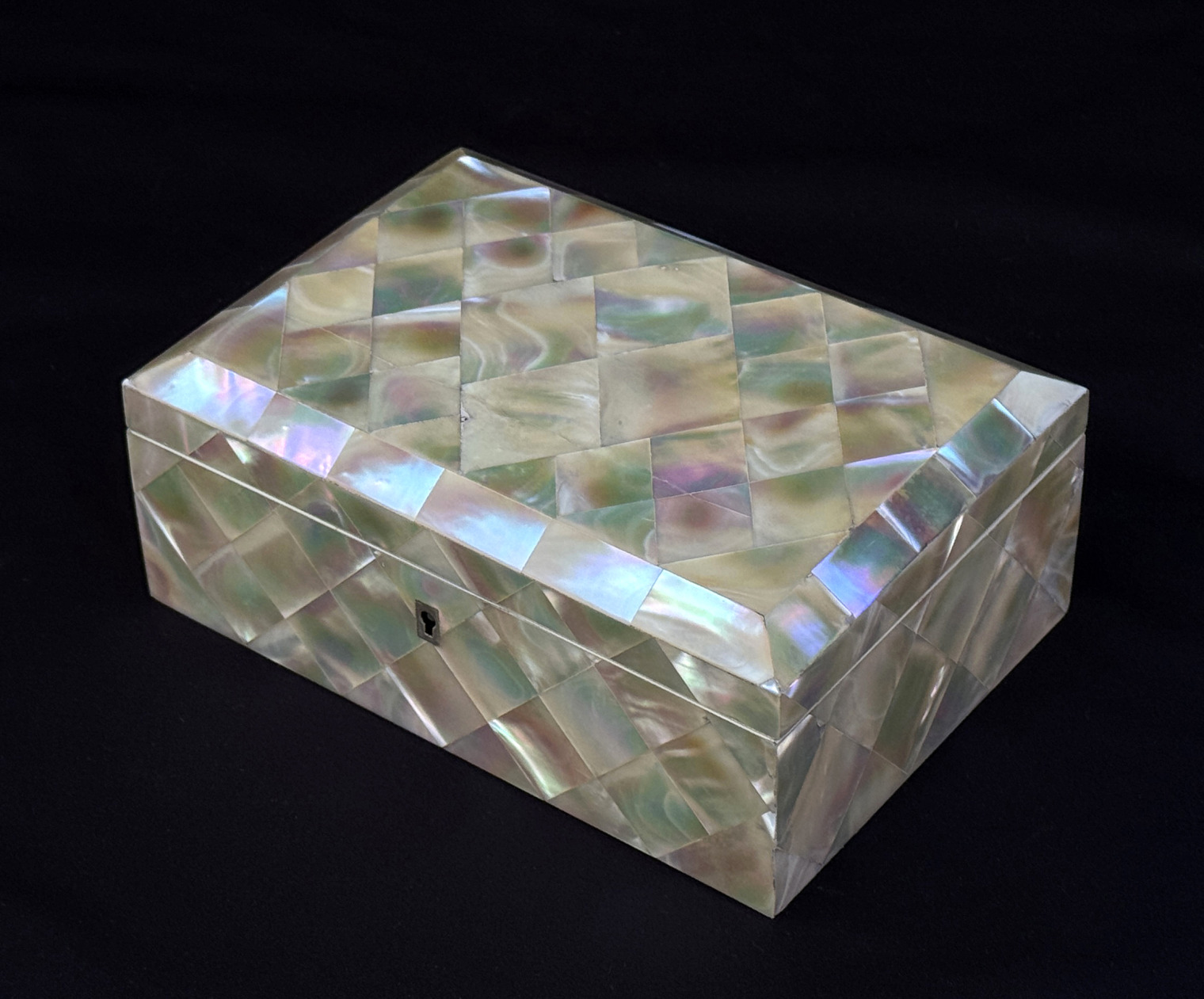 Front right view of an antique mother of pearl inlaid jewellery box.