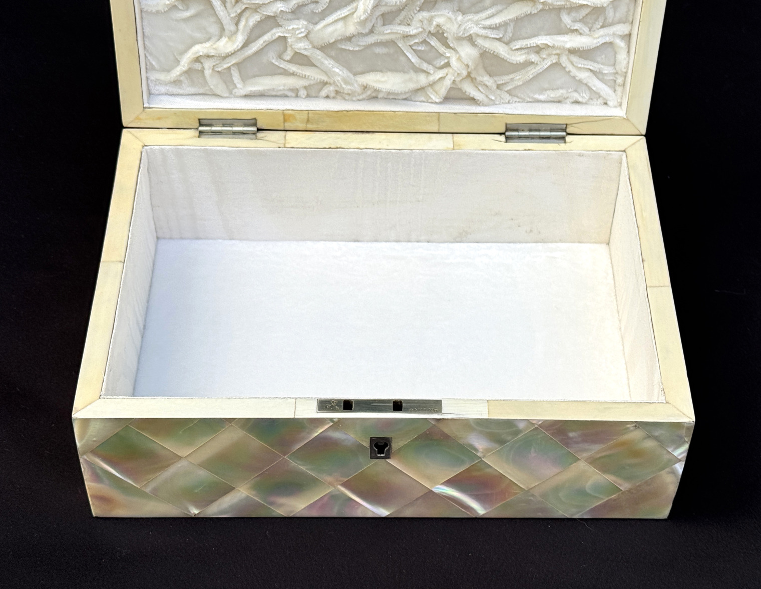 Closer overhead interior view of an antique mother of pearl inlaid jewellery box.