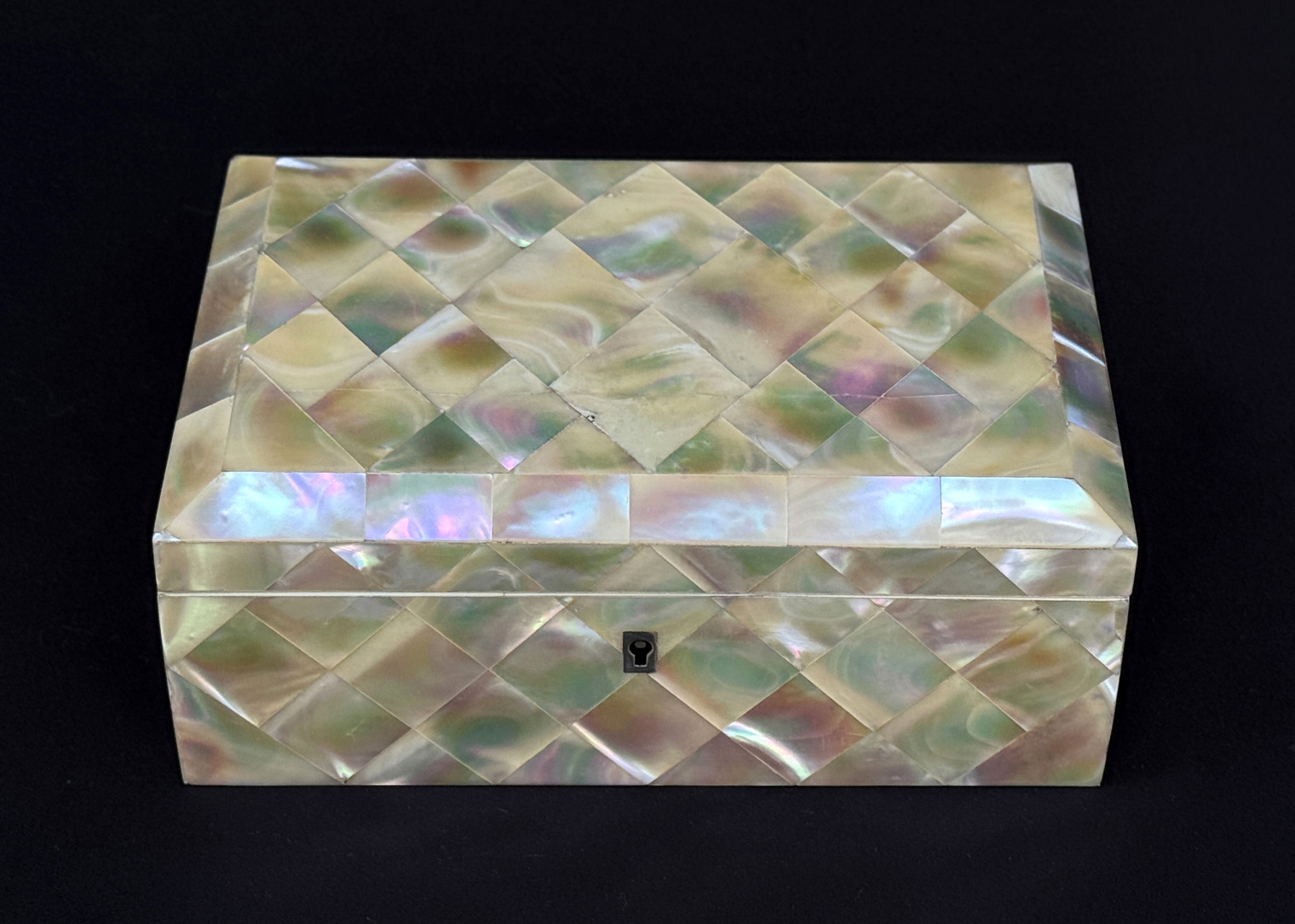Overhead view of an antique mother of pearl inlaid jewellery box.