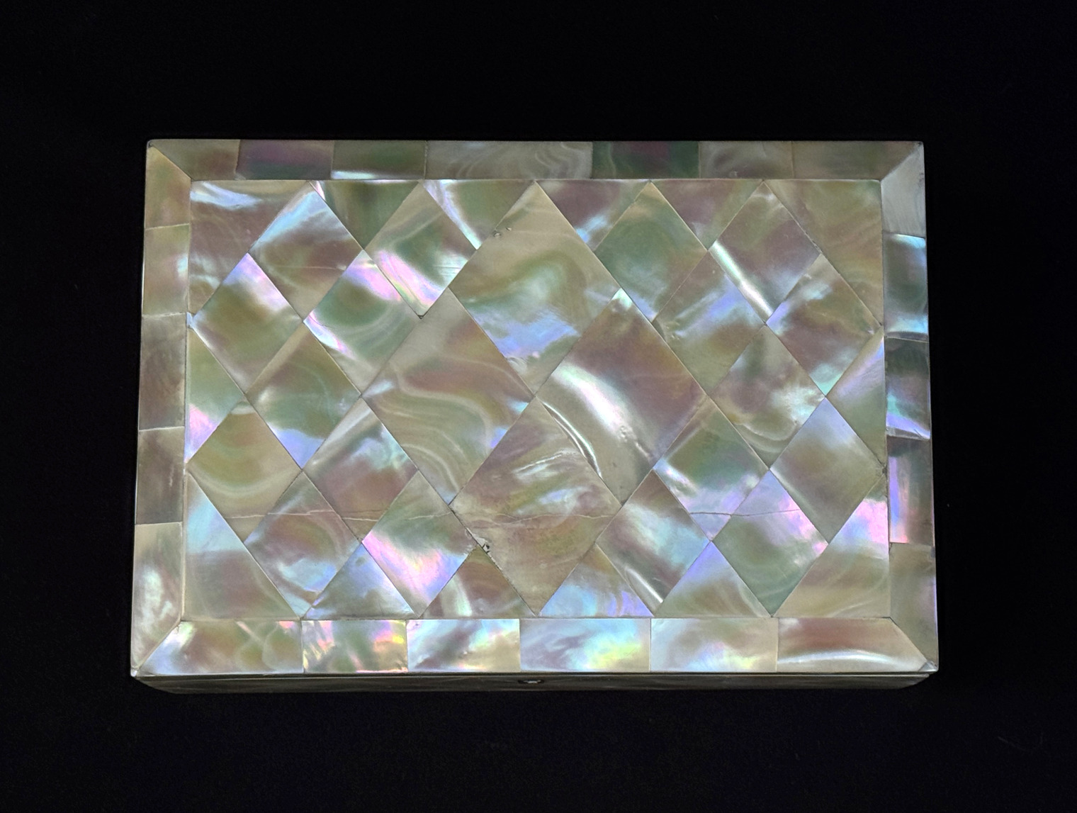 Overhead view of an antique mother of pearl inlaid jewellery box.
