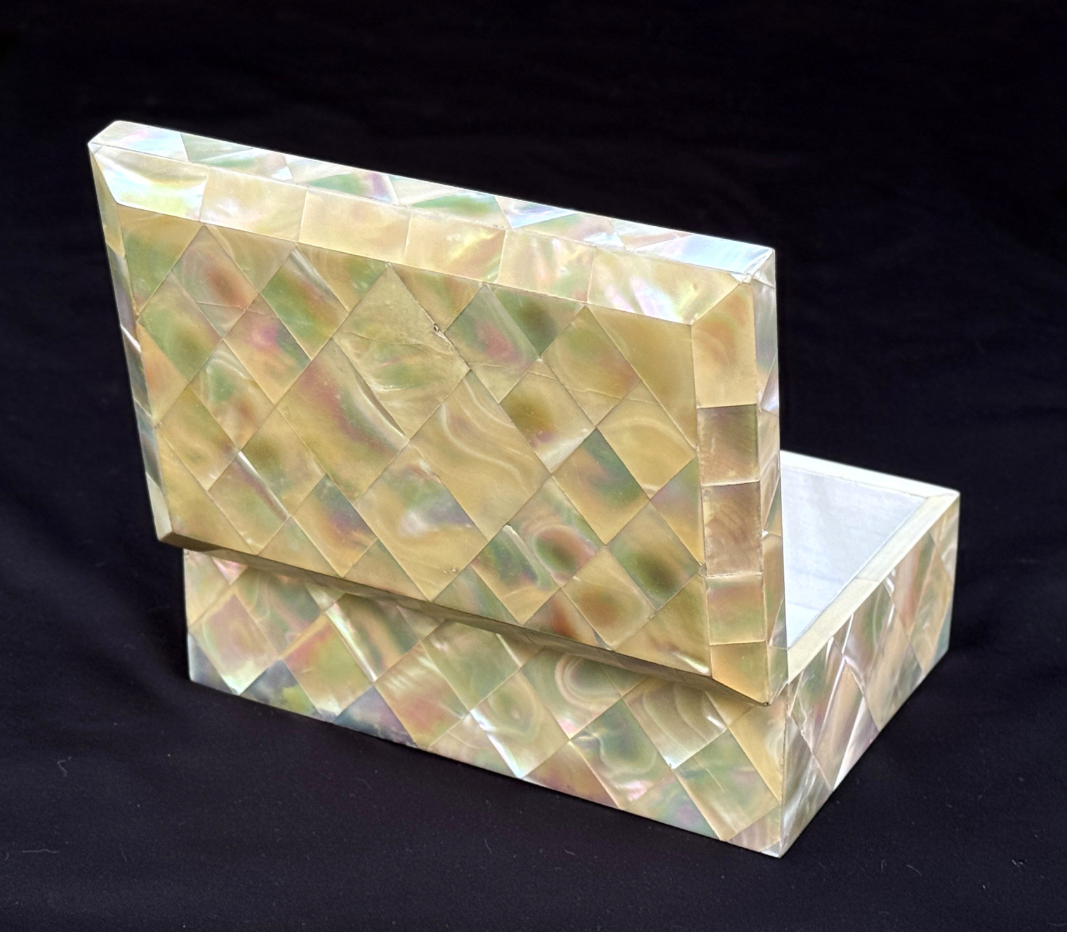 Rear left opened view of an antique mother of pearl inlaid jewellery box.
