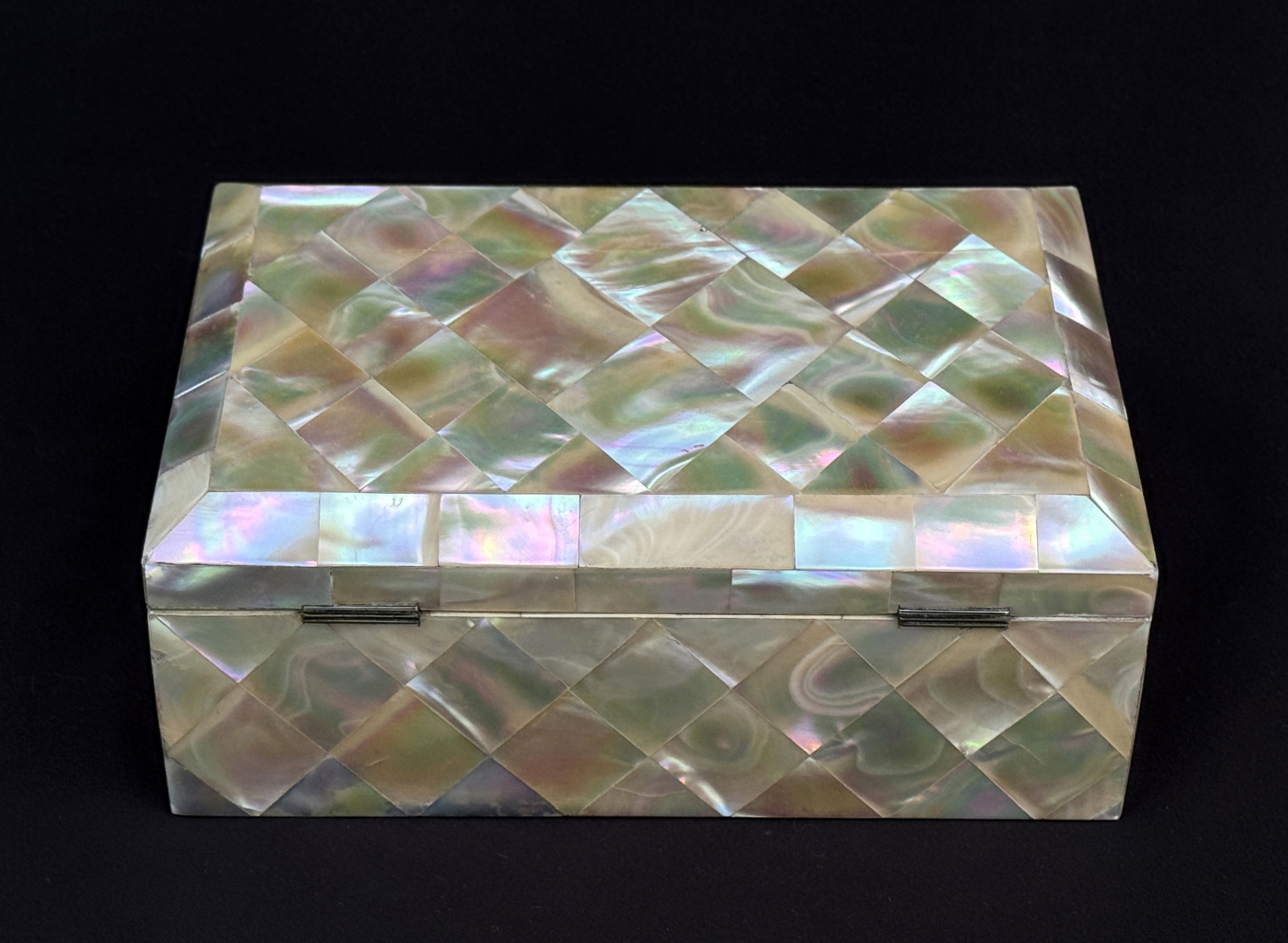 Rear view of an antique mother of pearl inlaid jewellery box.