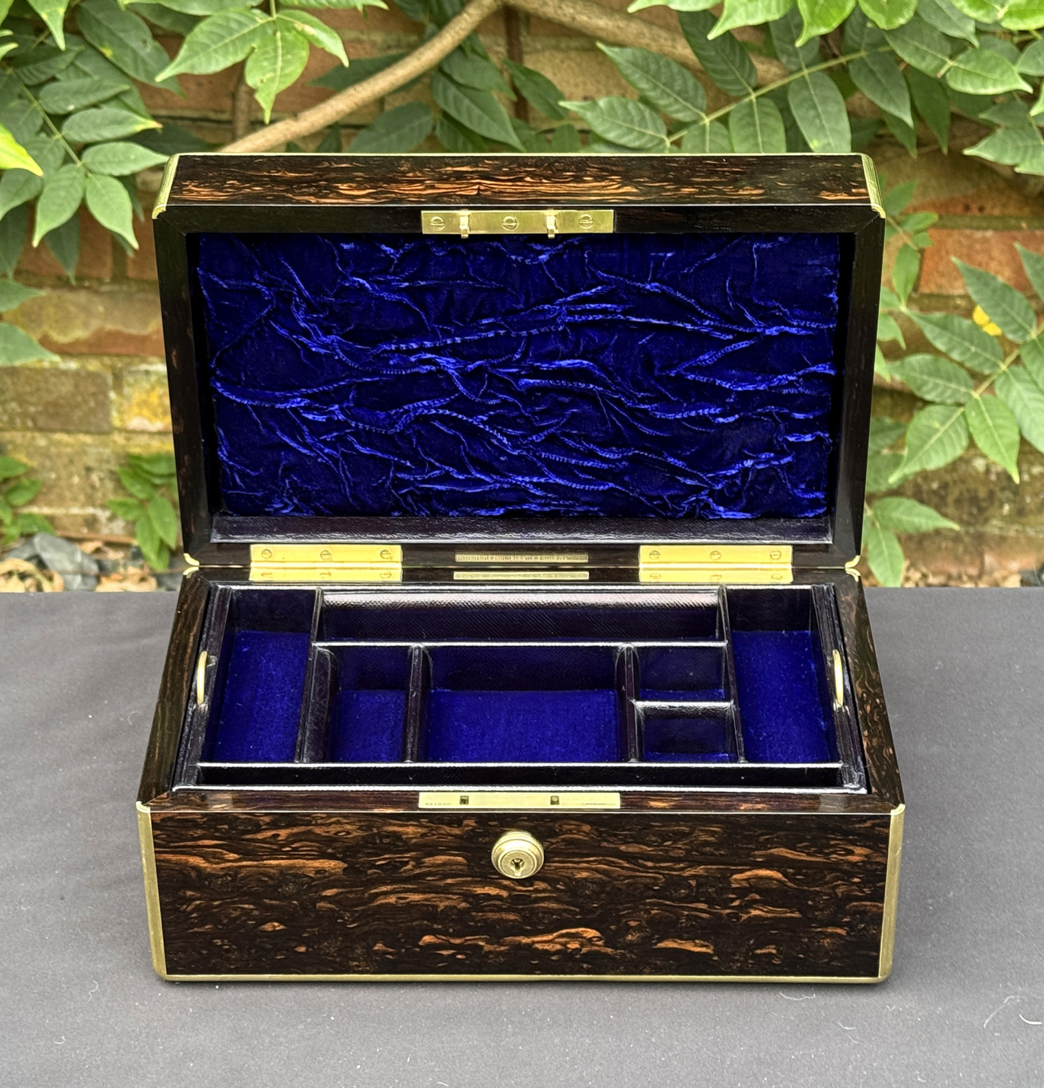 Front internal view of an antique gentleman's travelling jewellery box in coromandel, by Houghton & Gunn, with jewellery tray fitted.