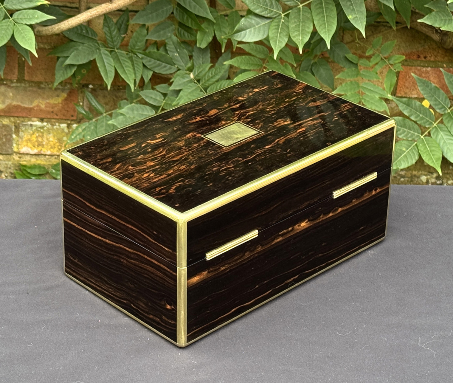 Rear right view of an antique gentleman's travelling jewellery box in coromandel, by Houghton & Gunn.