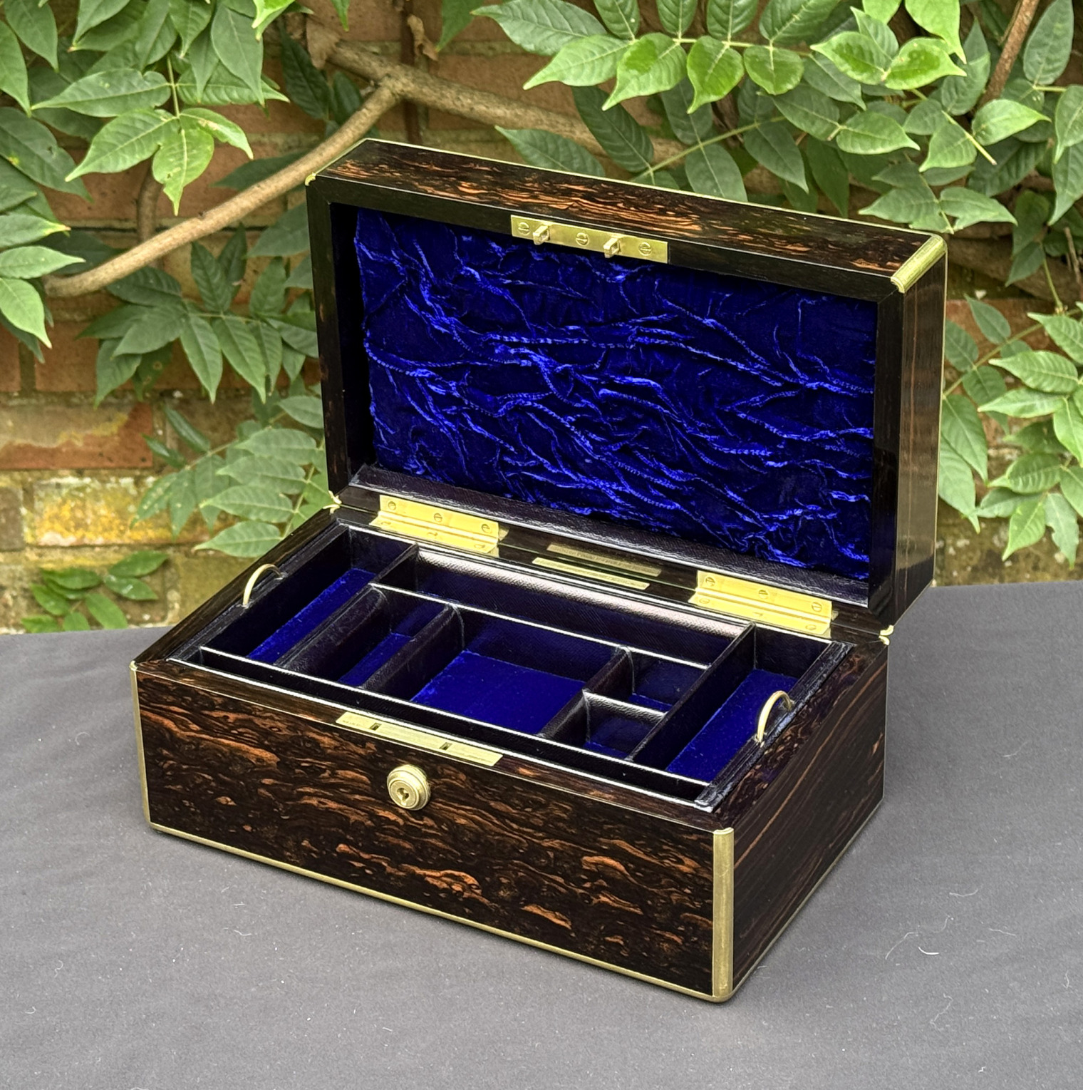 Front right internal view of an antique gentleman's travelling jewellery box in coromandel, by Houghton & Gunn.