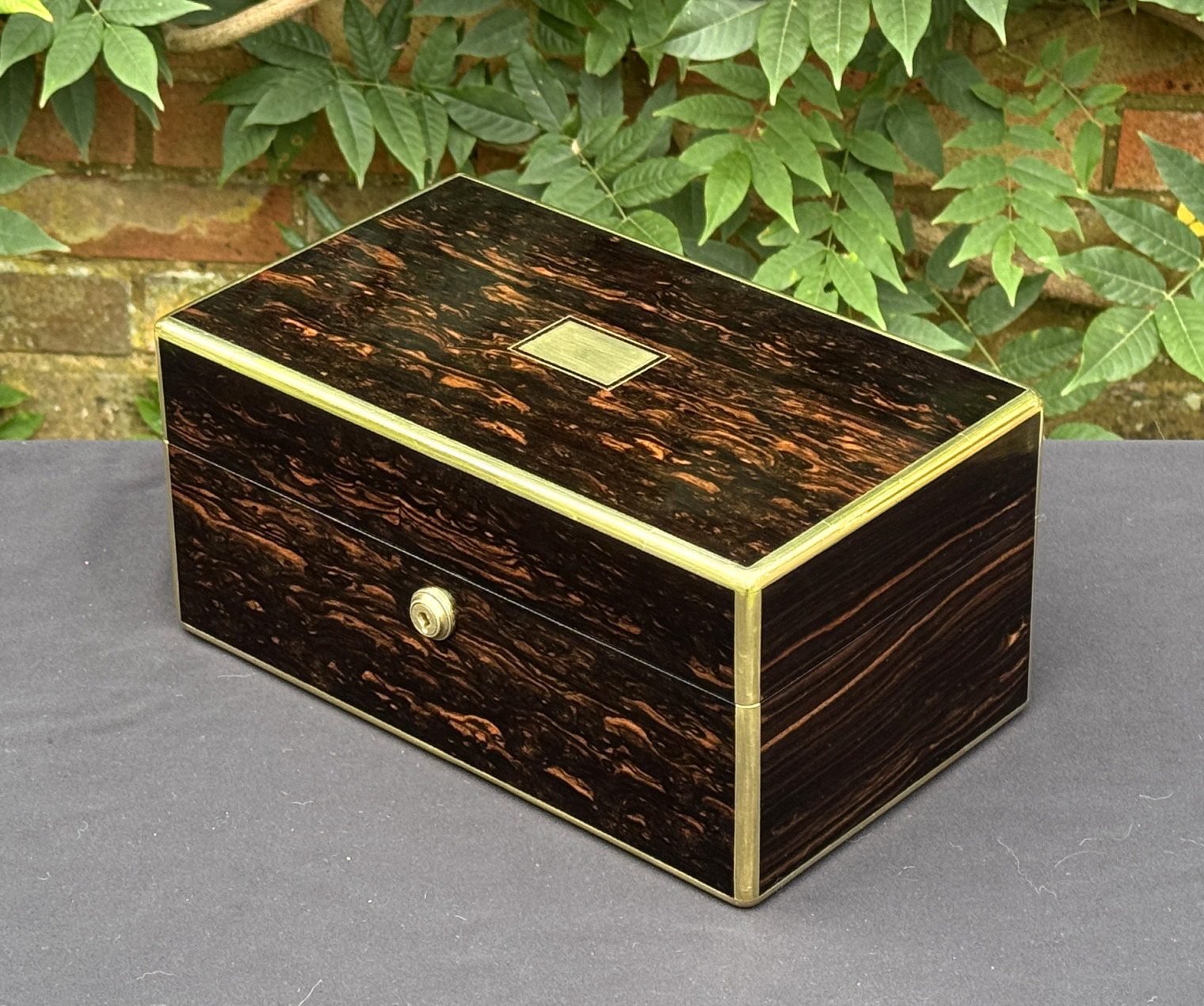 Front right view of an antique gentleman's travelling jewellery box in coromandel, by Houghton & Gunn.
