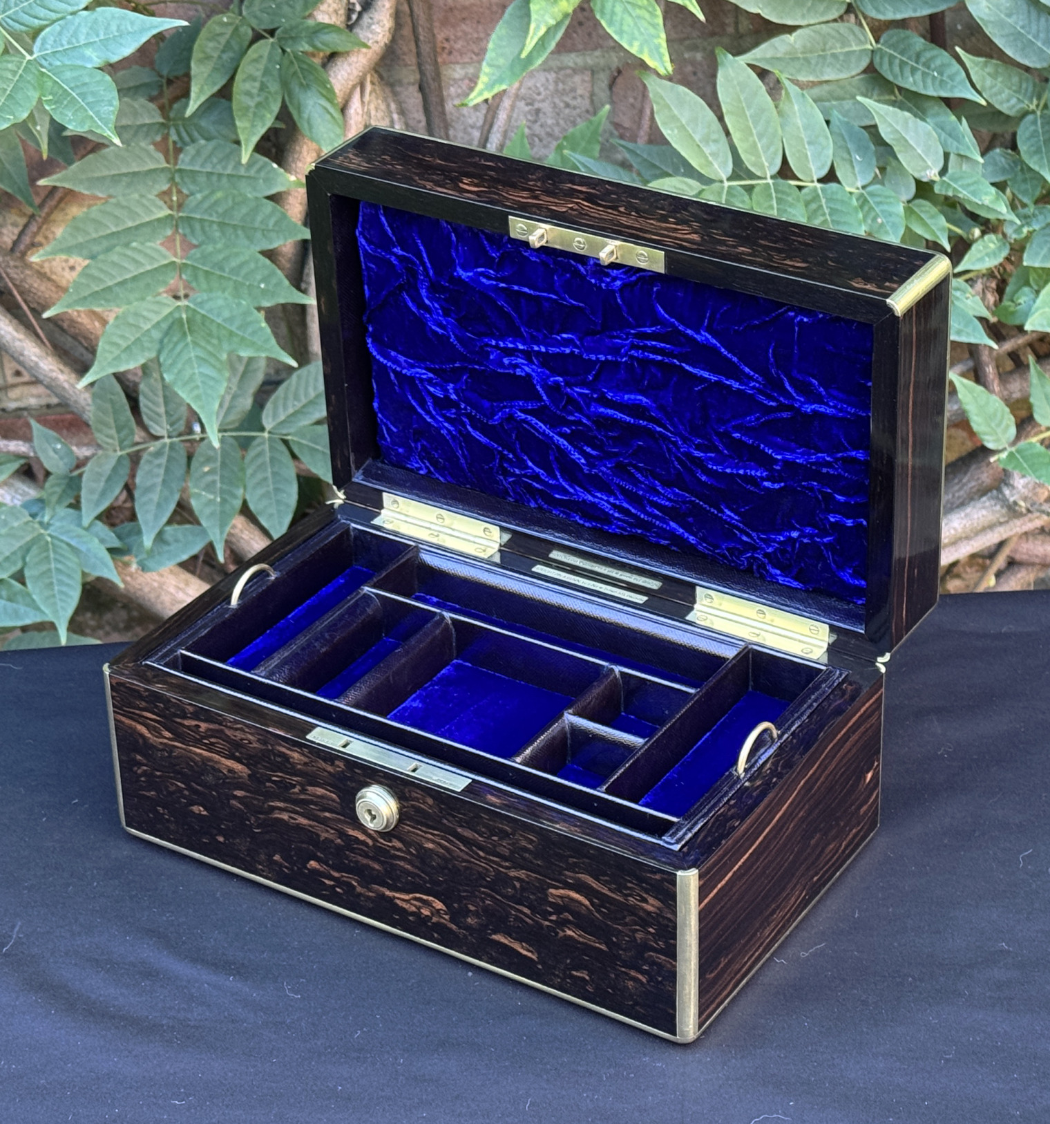 Front right internal view of an antique gentleman's travelling jewellery box in coromandel, by Houghton & Gunn.