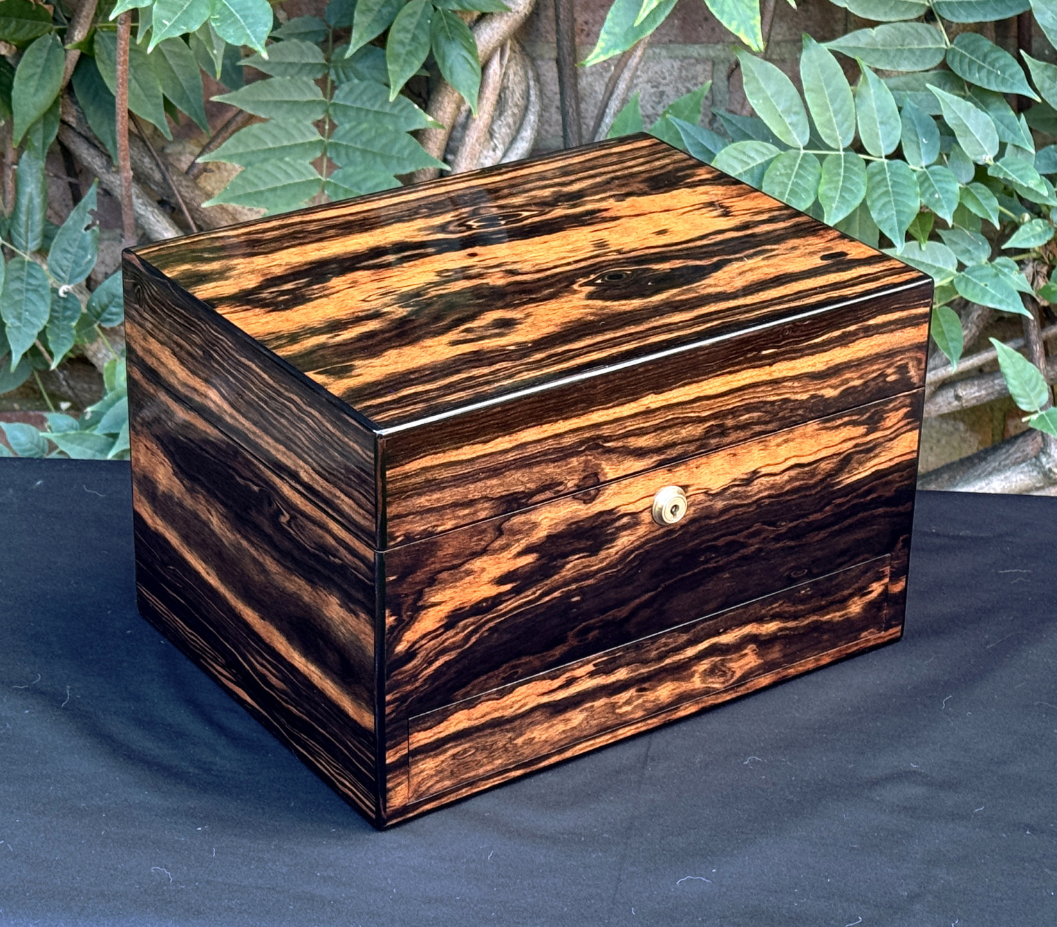 Front left view of an antique jewellery box in calamander, by George Betjemann & Sons.
