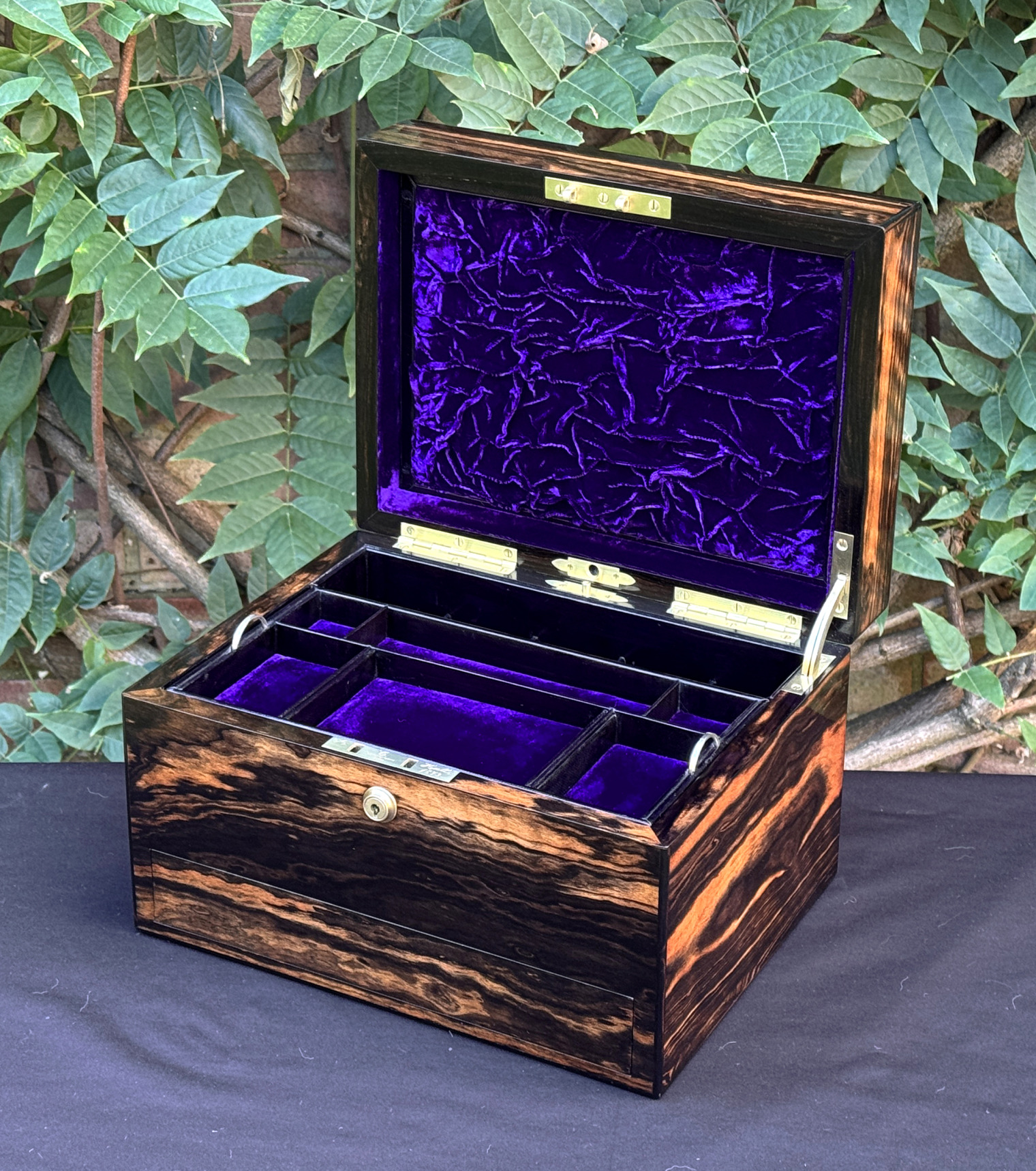 Front right interior view of an antique jewellery box in calamander, by George Betjemann & Sons.