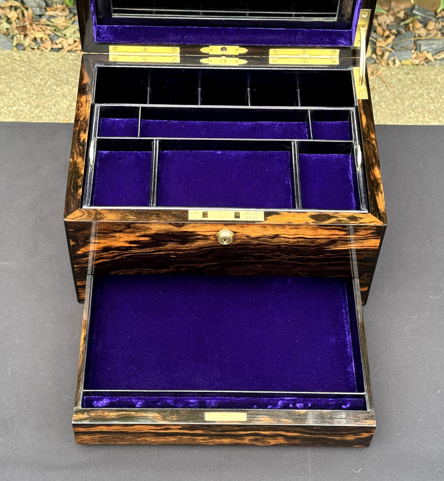 Closer interior view of an antique jewellery box in calamander, by George Betjemann & Sons, with lower drawer fully extended.