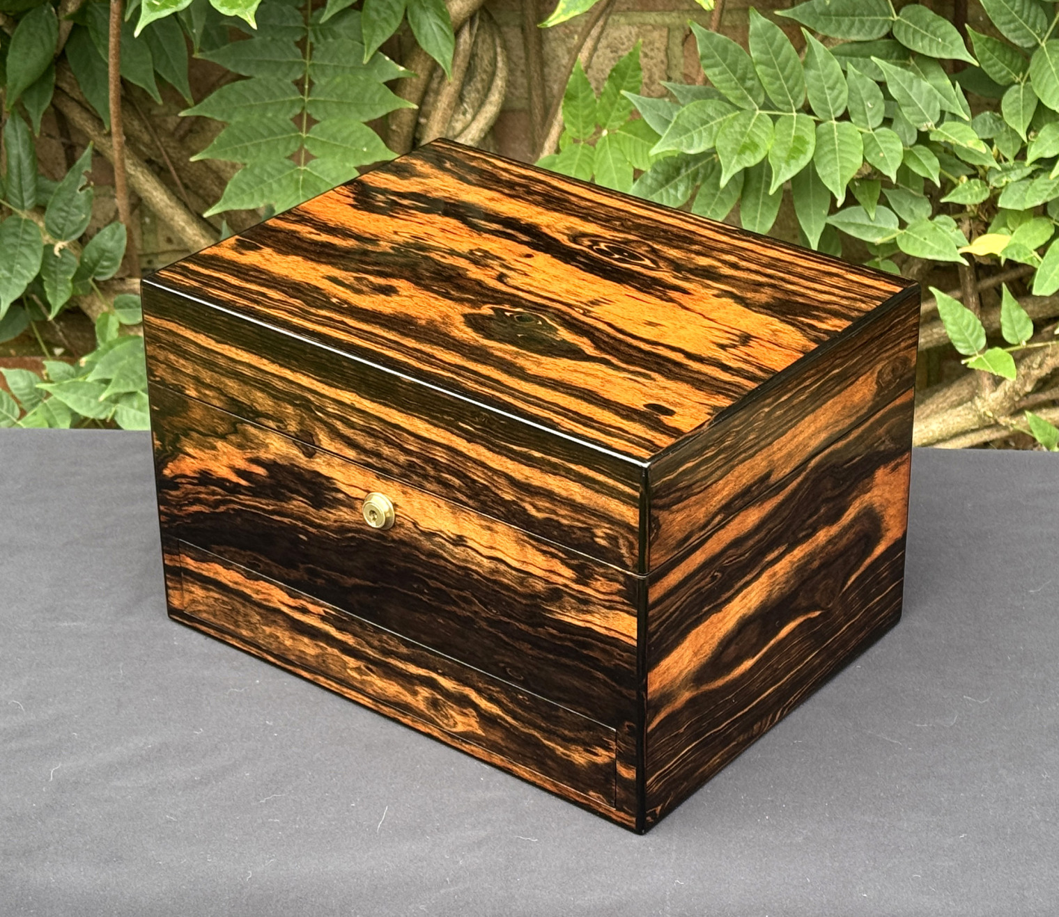 Front right view of an antique jewellery box in calamander, by George Betjemann & Sons.