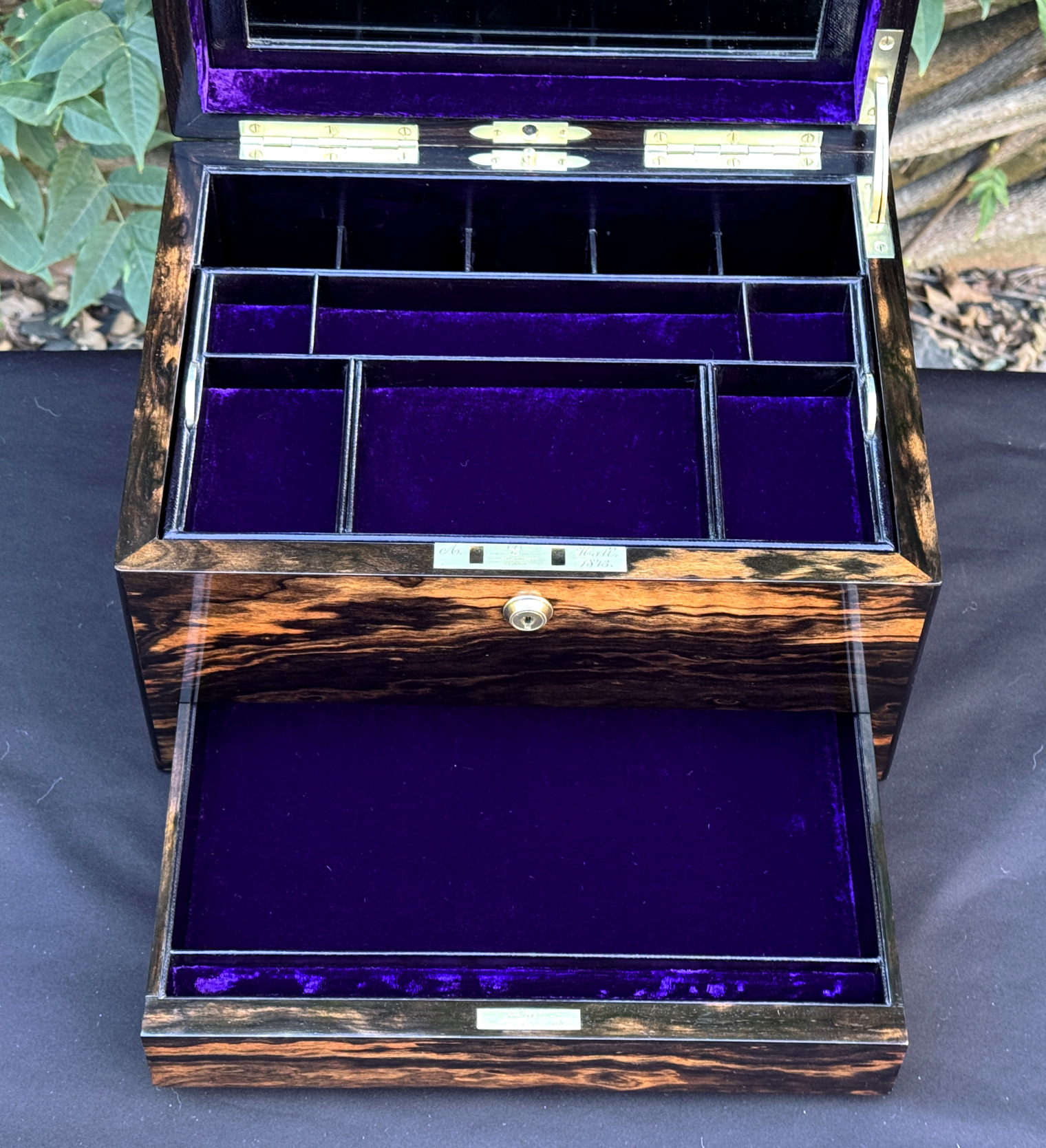 Closer interior view of an antique jewellery box in calamander, by George Betjemann & Sons, with lower drawer fully extended.