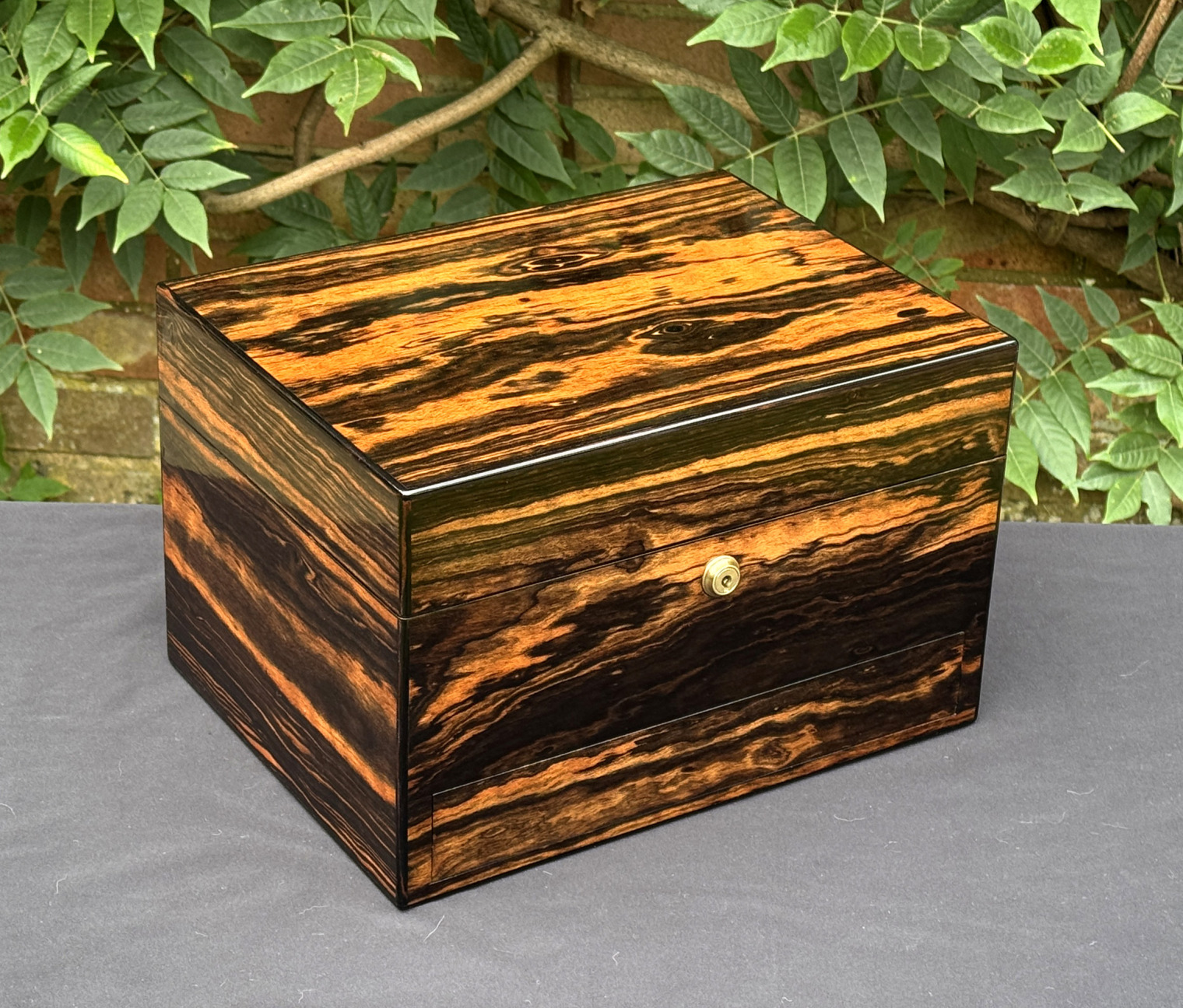 Front left view of an antique jewellery box in calamander, by George Betjemann & Sons.