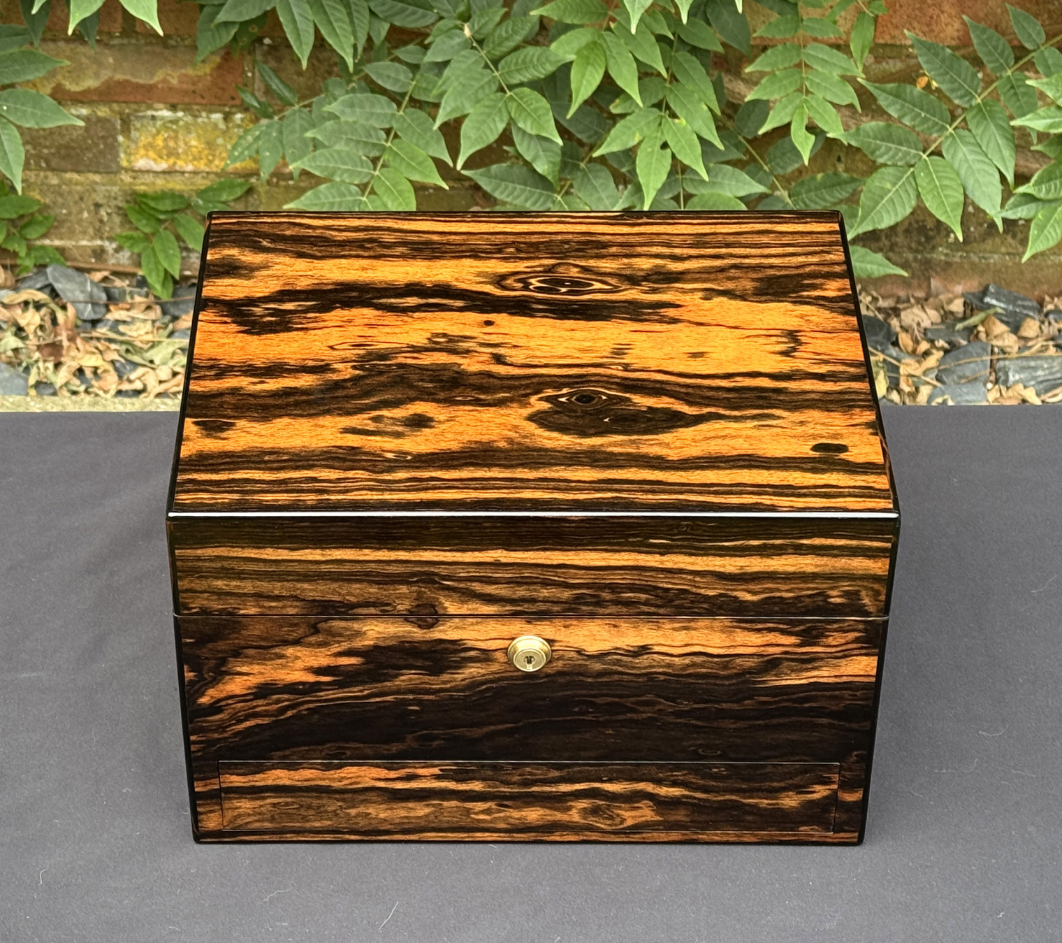 Overhead view of an antique jewellery box in calamander, by George Betjemann & Sons.