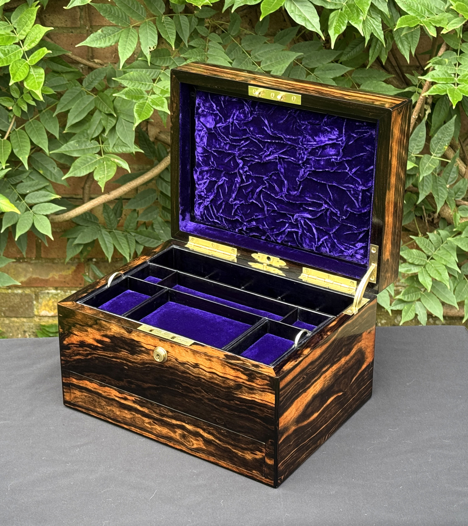 Front right interior view of an antique jewellery box in calamander, by George Betjemann & Sons.