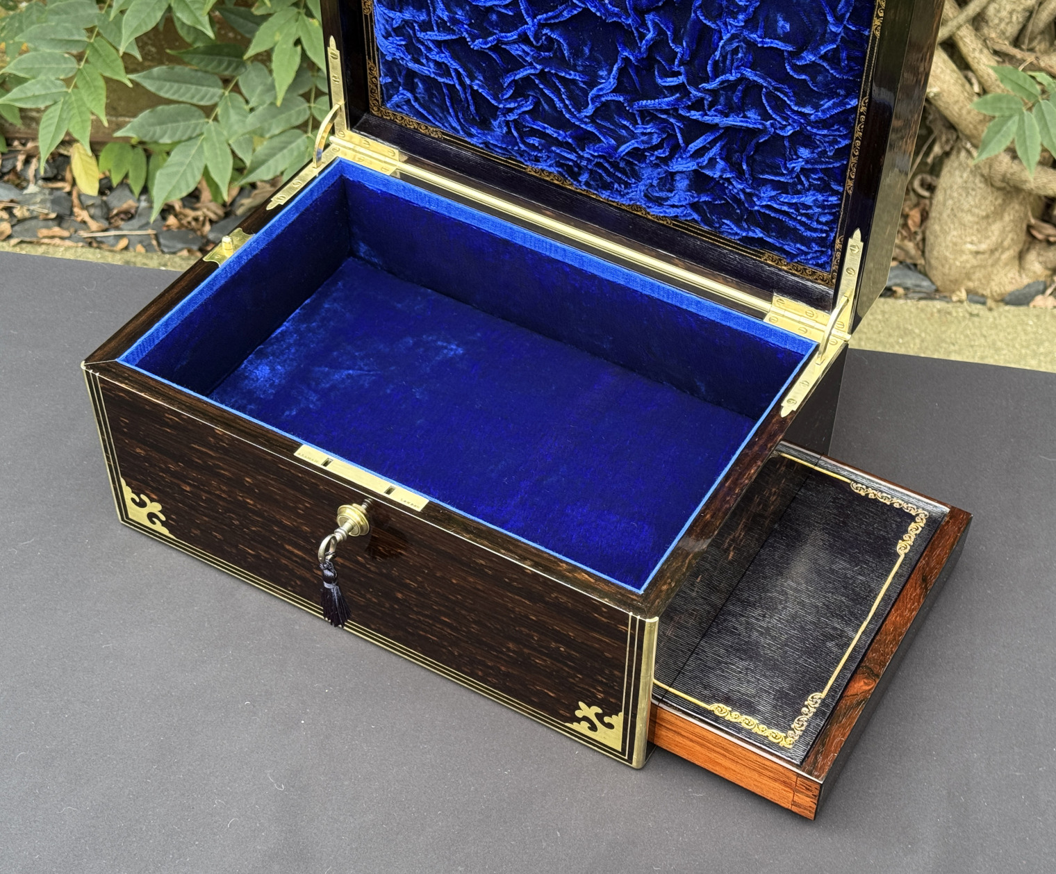 Closer interior view of an antique jewellery box in coromandel, by Thomas Dalton, with side drawer partially extended.