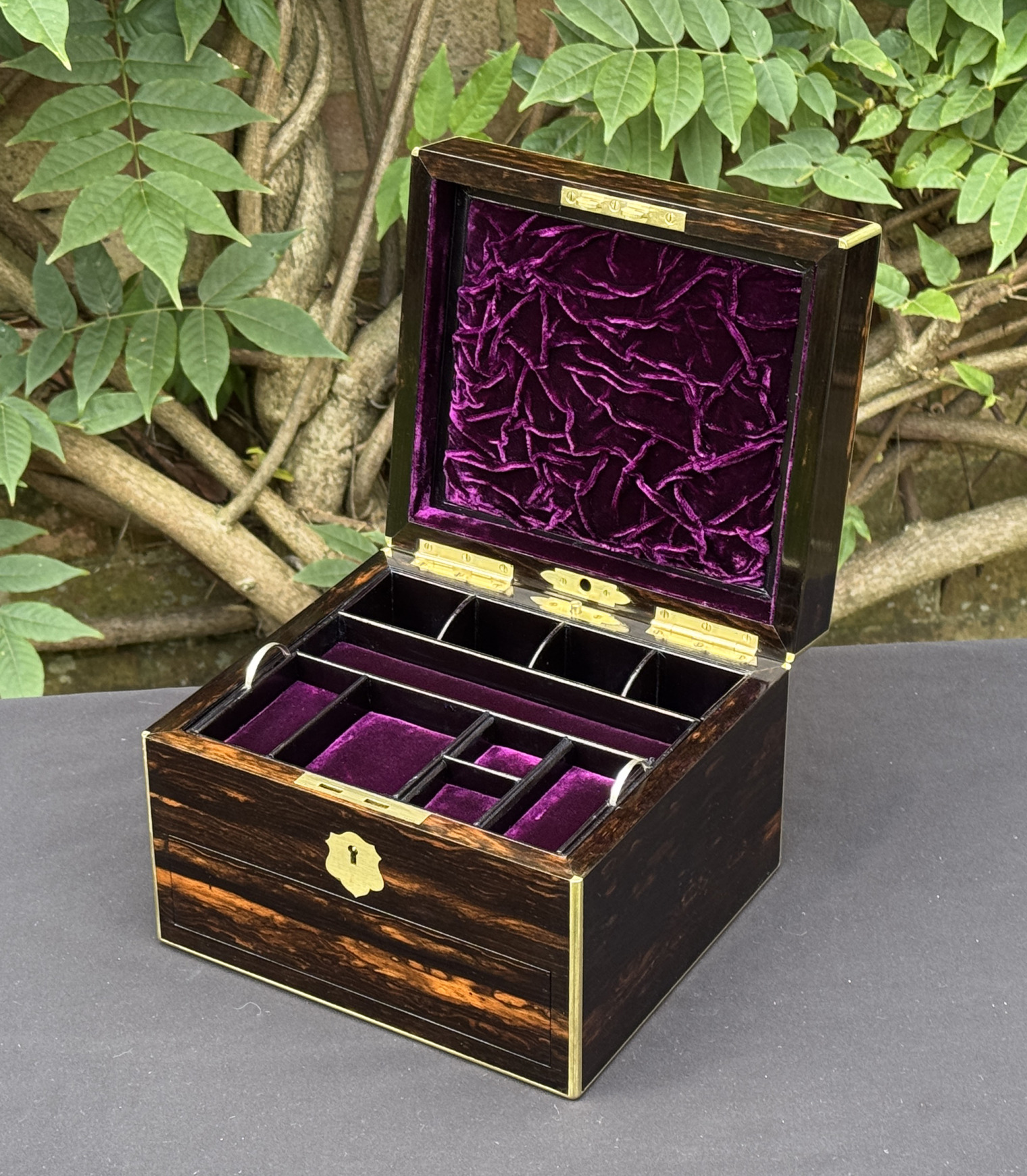 Front right interior view of a miniature antique jewellery box in coromandel, by George Betjemann & Sons.