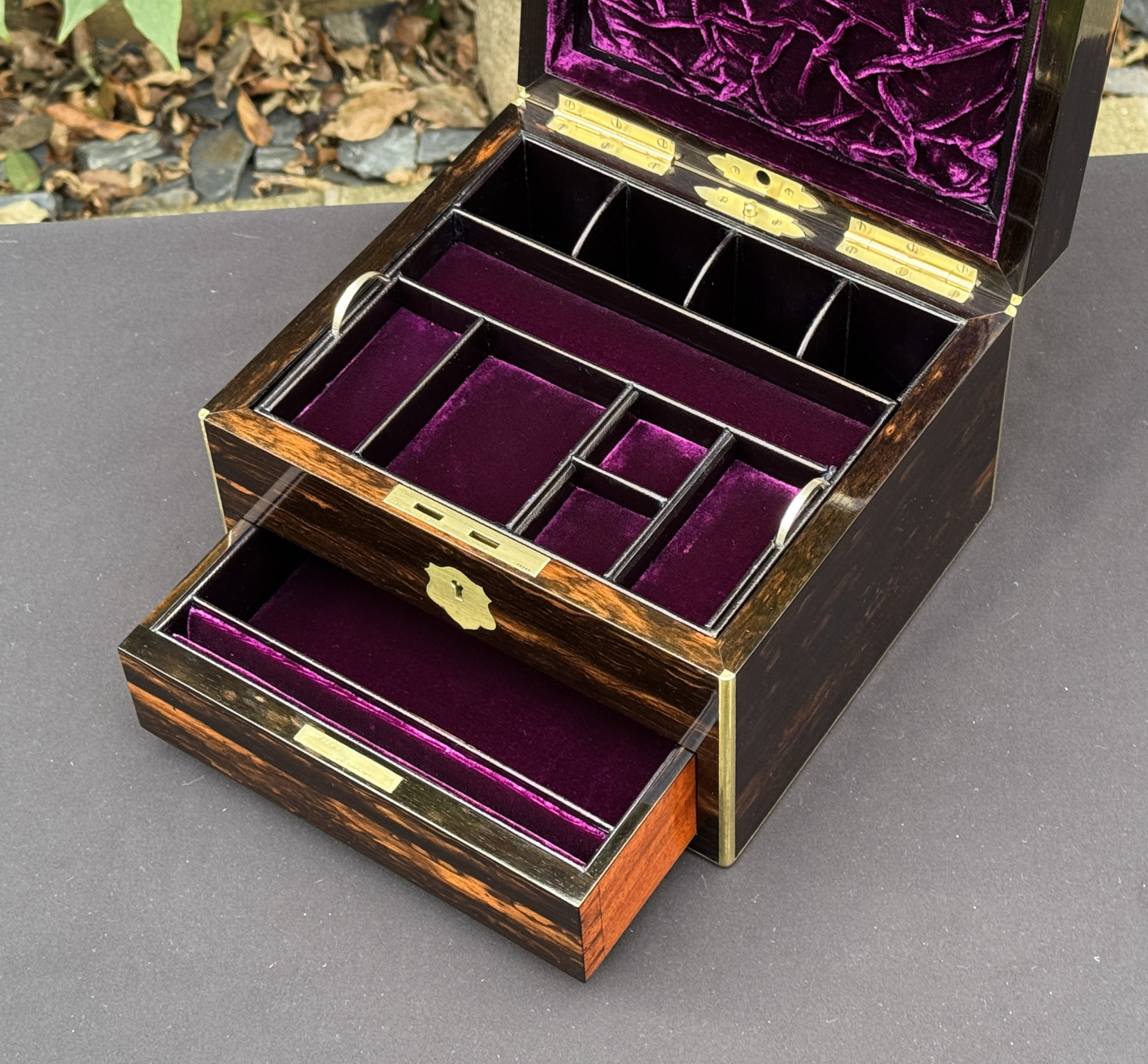 Closer interior view of a miniature antique jewellery box in coromandel, by George Betjemann & Sons, with lower drawer extended.