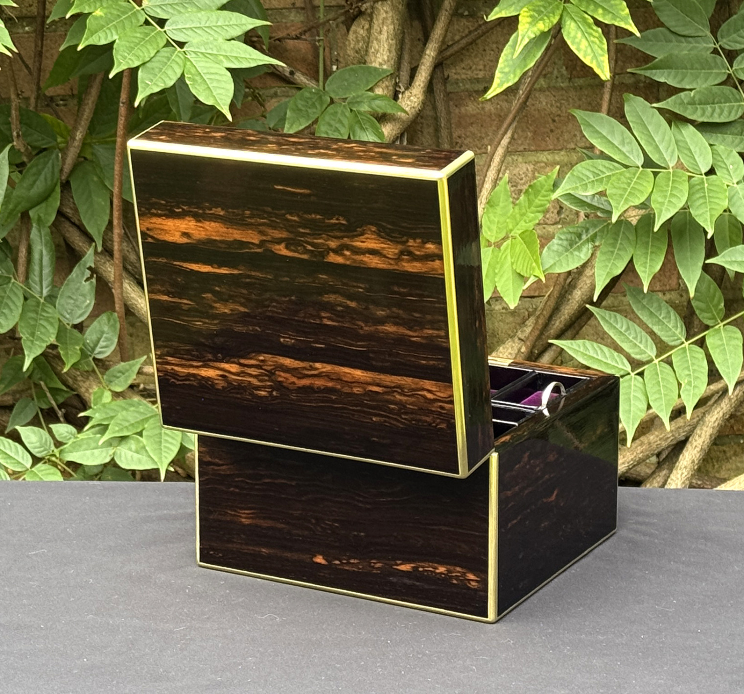 Rear left opened view of a miniature antique jewellery box in coromandel, by George Betjemann & Sons.