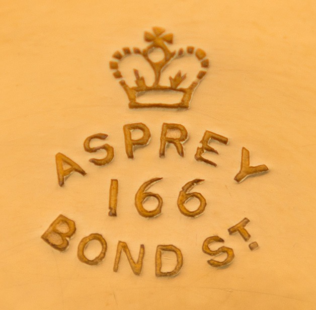 ‘Asprey – 166 Bond St’ stamped into a silver-gilt dressing case fitting.