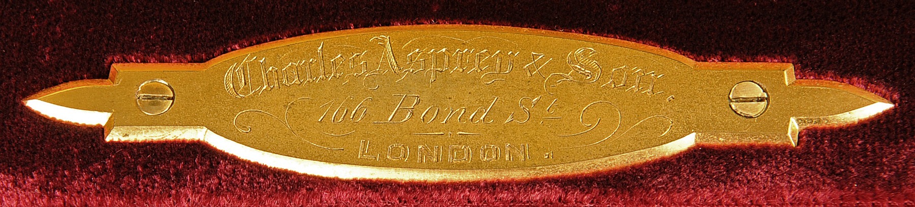 Charles Asprey & Son gilt-brass manufacturer’s plate from an antique jewellery box with Betjemann Patent mechanism and candlesticks.