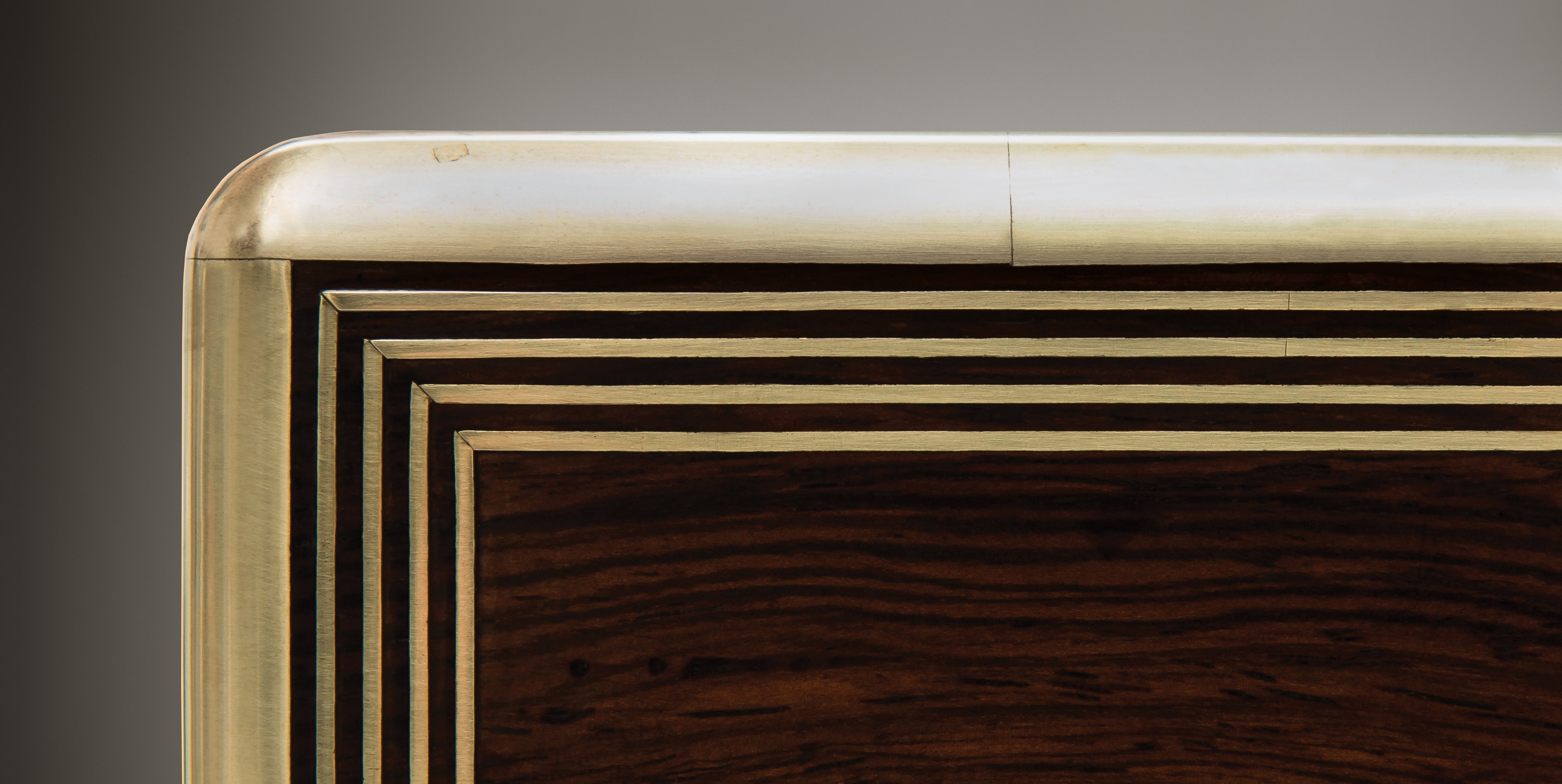 Inlaid quadruple brass stringing from an antique rosewood jewellery box.