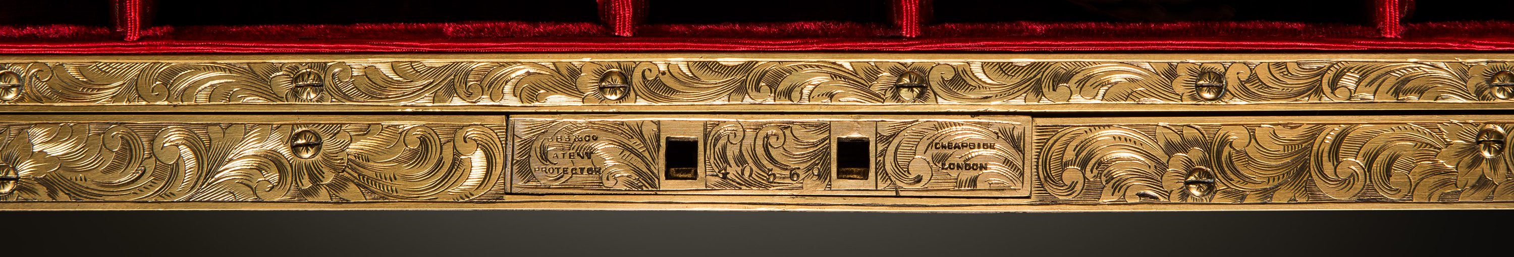 Brass lock plate and internal facing engraved with a floral and scrollwork design, from an antique jewellery box in coromandel with engraved brass inlay.