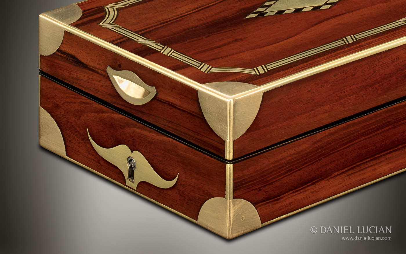 Quadrant shaped brass corner mounts and inset central brass finger plate to aid lid opening. The brass finger plate being another definitive hallmark of French design.