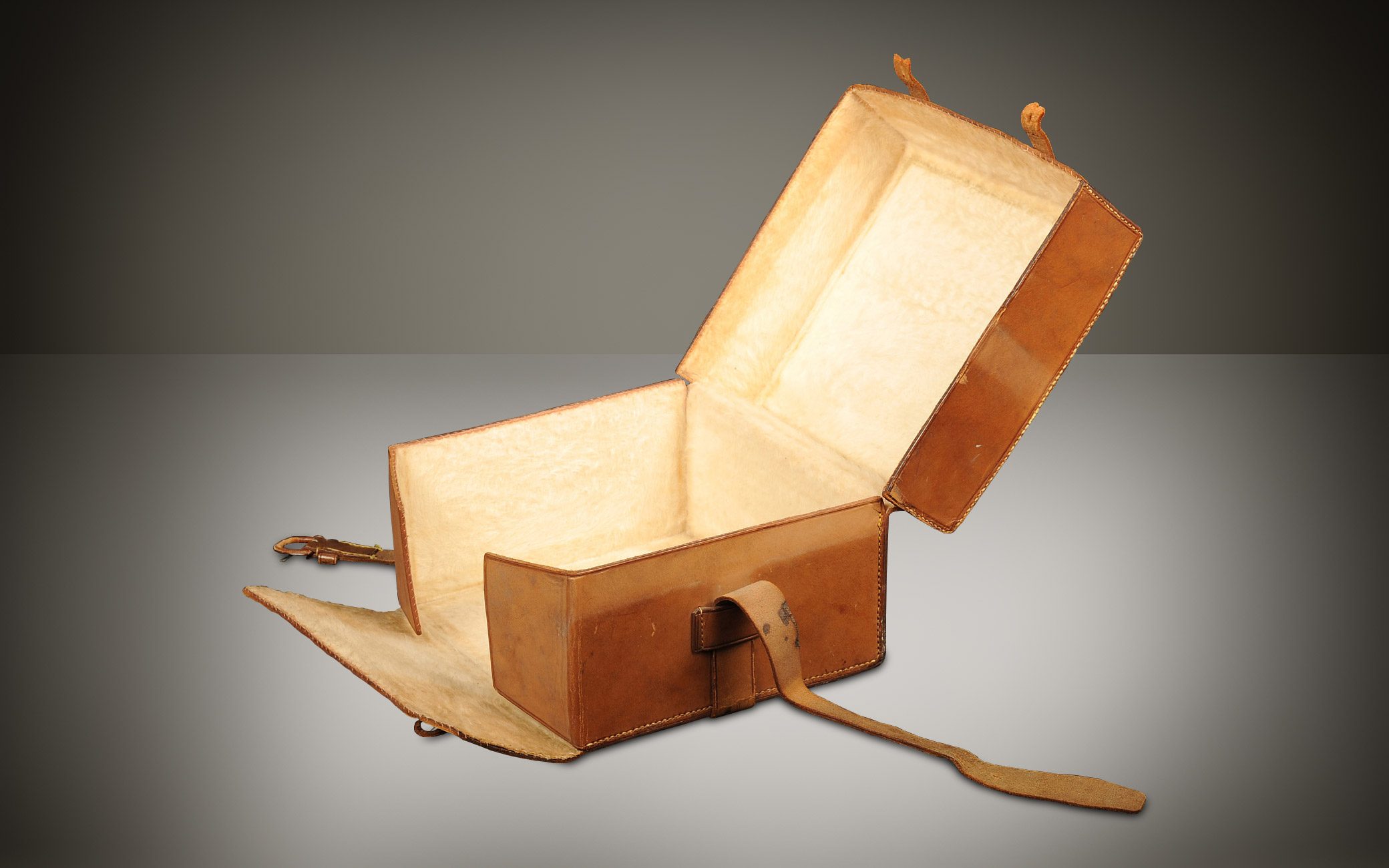 Leather outer case for a miniature antique dressing case in burr walnut.