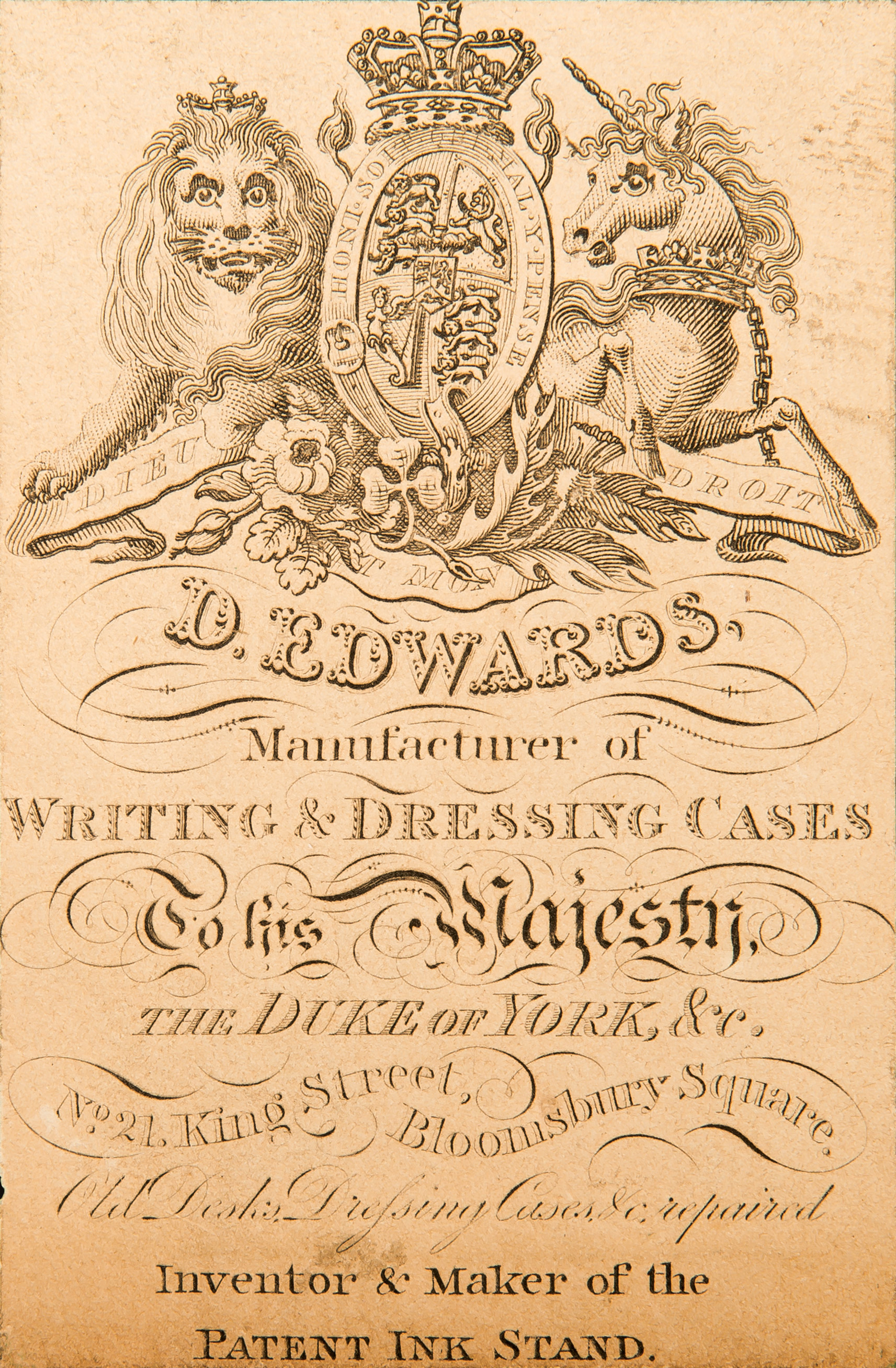 The ruched velvet flap in the lid drops down to reveal a concealed leather-bound letter wallet on the reverse. Adhered to the exterior of the letter wallet is this paper label belonging to the manufacturer and retailer, Edwards of 21 King Street, Bloomsbury Square, London.