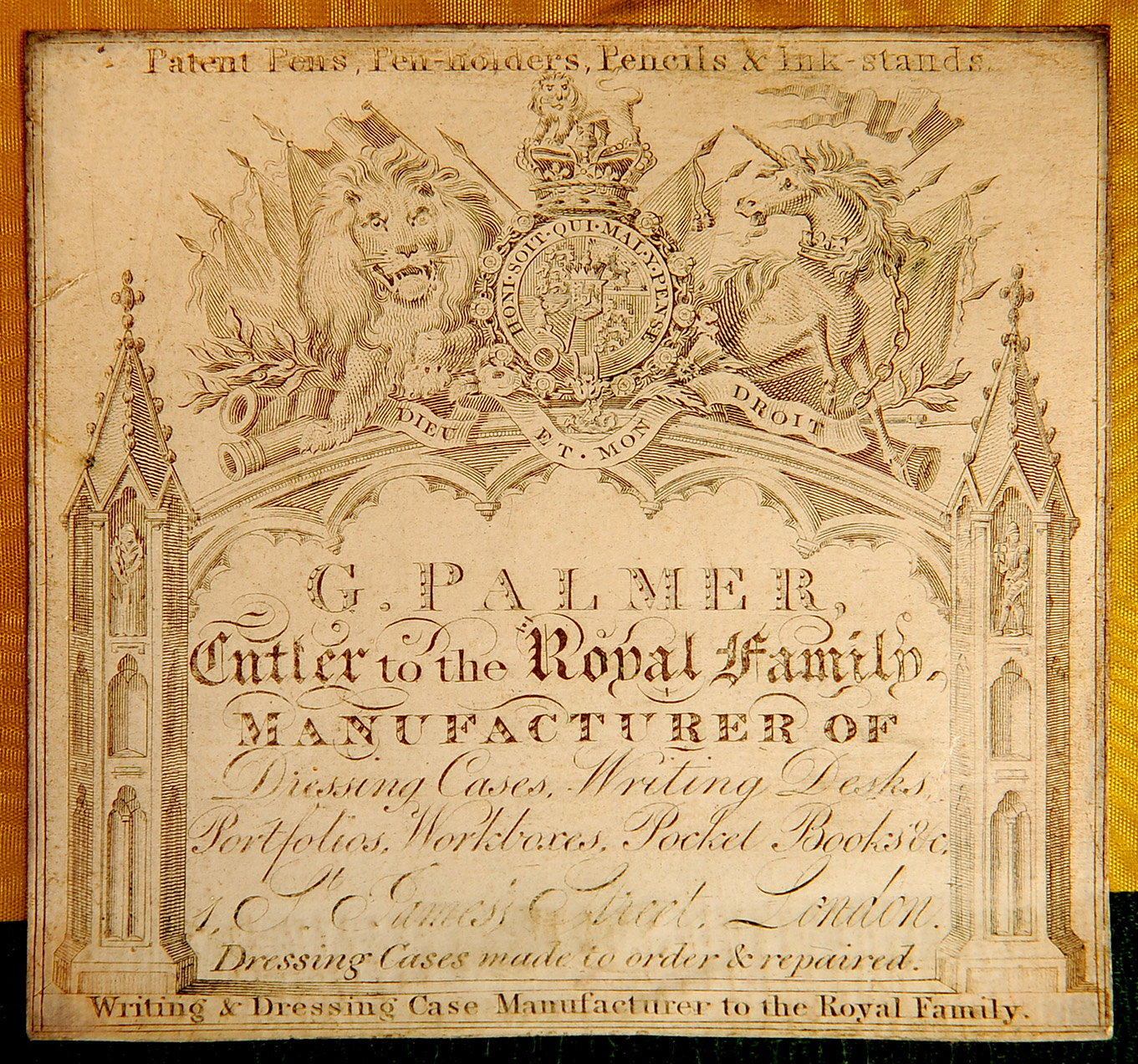 The ruched velvet flap in the lid drops down to reveal a concealed leather-bound letter wallet on the reverse. Adhered to the interior of the letter wallet is this paper label belonging to the manufacturer and retailer, George Palmer of 1 St James’s Street, London.