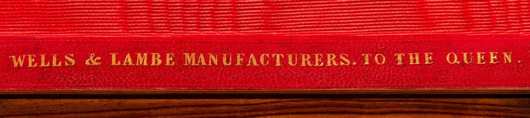 ‘Wells & Lambe Manufacturers To The Queen’ gold tooled manufacturer’s mark onto leather.